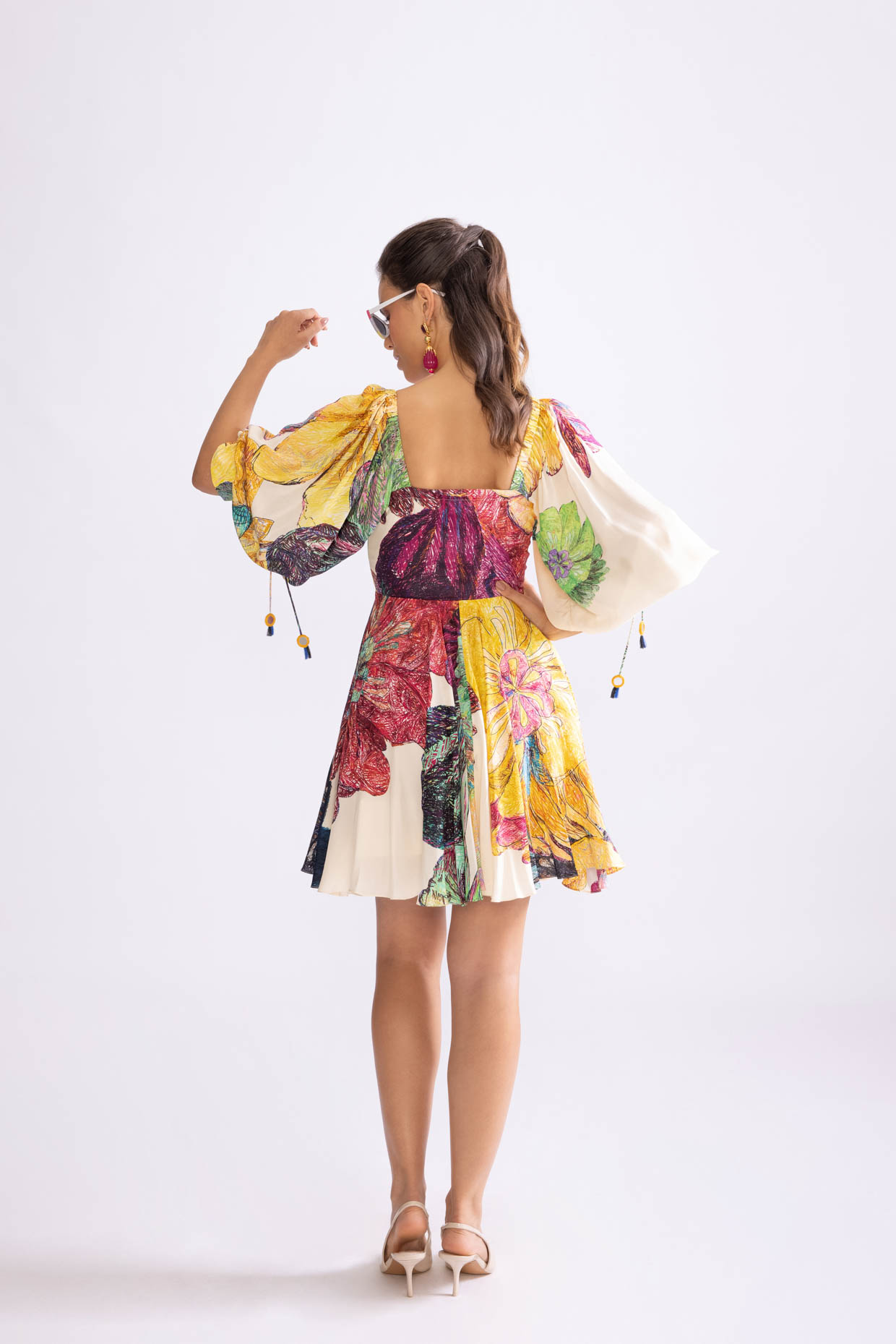 A model showcasing Savannah Dress Daisy Print Flared Mini Dress by Saaksha And Kinni from Saaksha And Kinni's collection