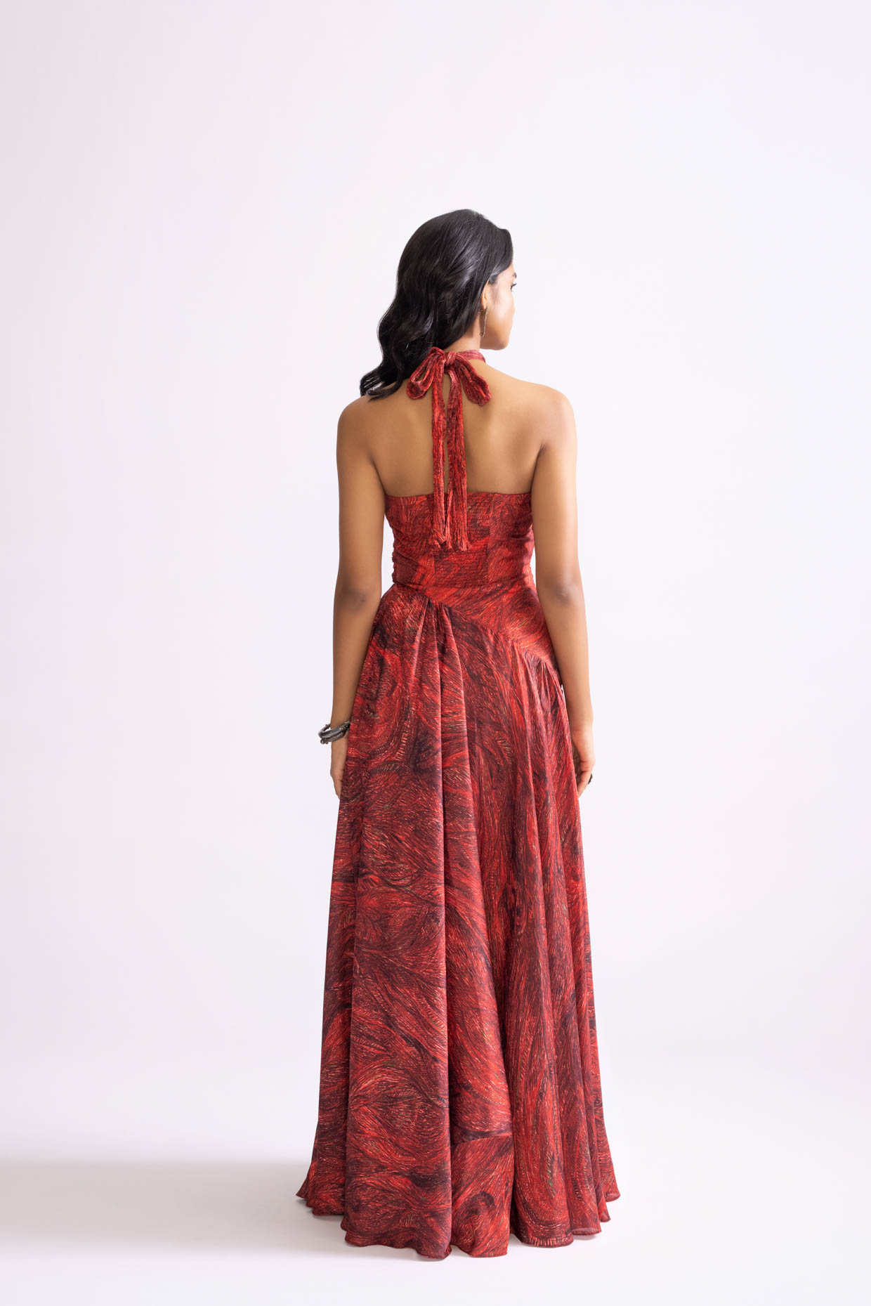 A model showcasing Clara Dress Printed Halter Neck Flared Dress by Saaksha And Kinni from Saaksha And Kinni's collection