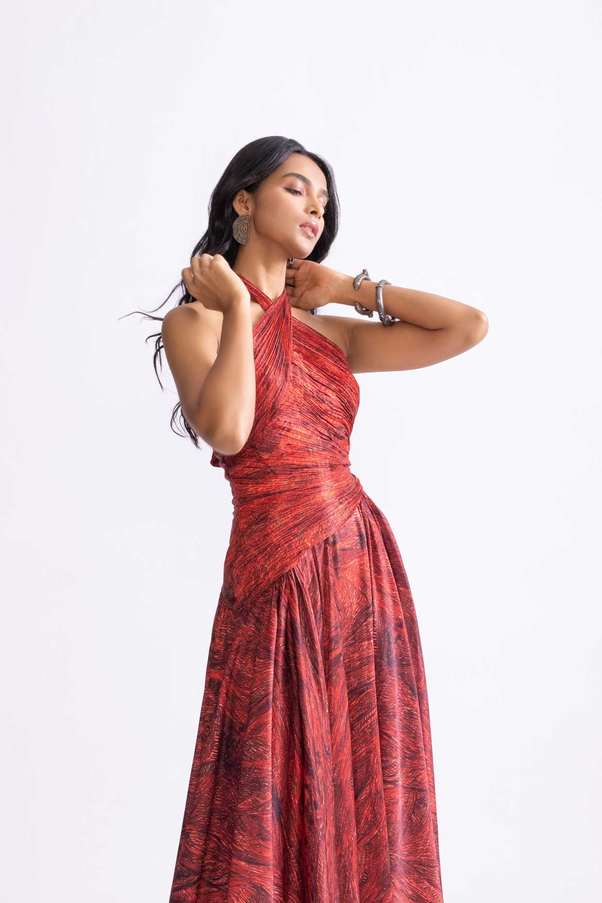 A model showcasing Clara Dress Printed Halter Neck Flared Dress by Saaksha And Kinni from Saaksha And Kinni's collection