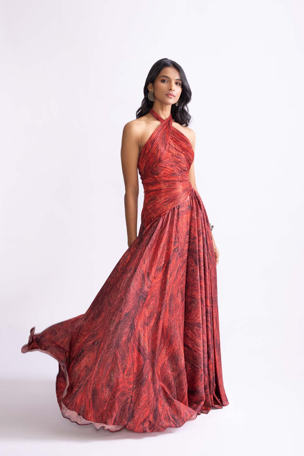 A model showcasing Clara Dress Printed Halter Neck Flared Dress by Saaksha And Kinni from Saaksha And Kinni's collection