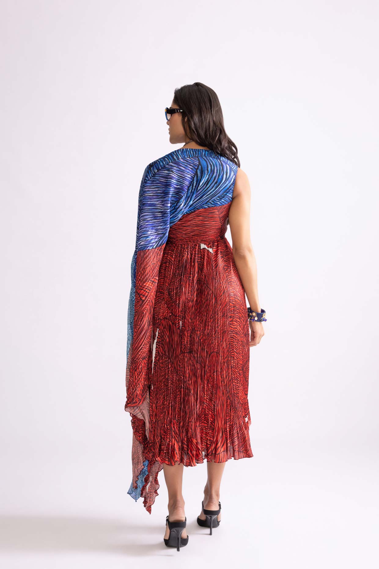 A model showcasing Abigail Dress Wave Print Micro Pleat Dress by Saaksha And Kinni from Saaksha And Kinni's collection