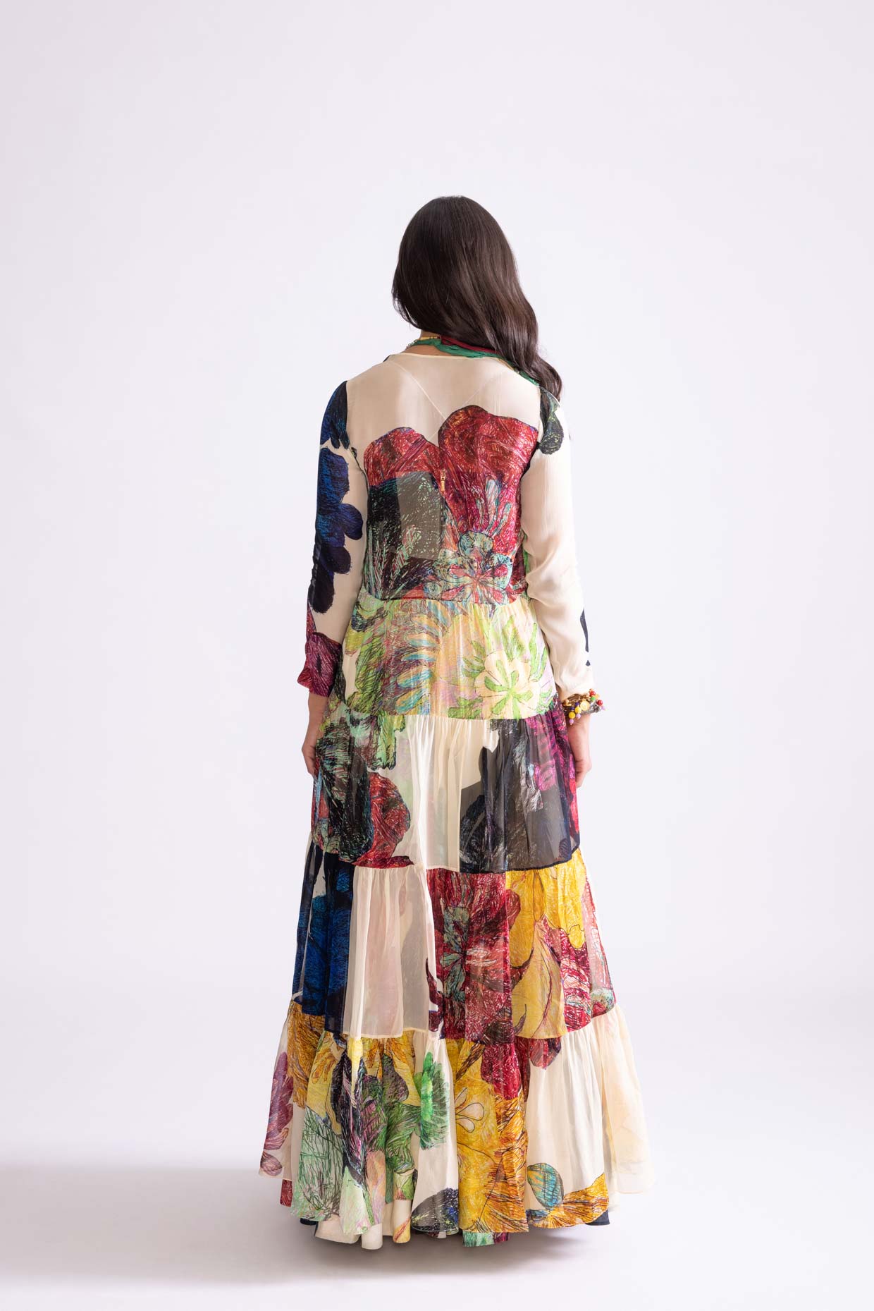 A model showcasing Magnolia Cape Daisy Print Tiered Cape by Saaksha And Kinni from Saaksha And Kinni's collection