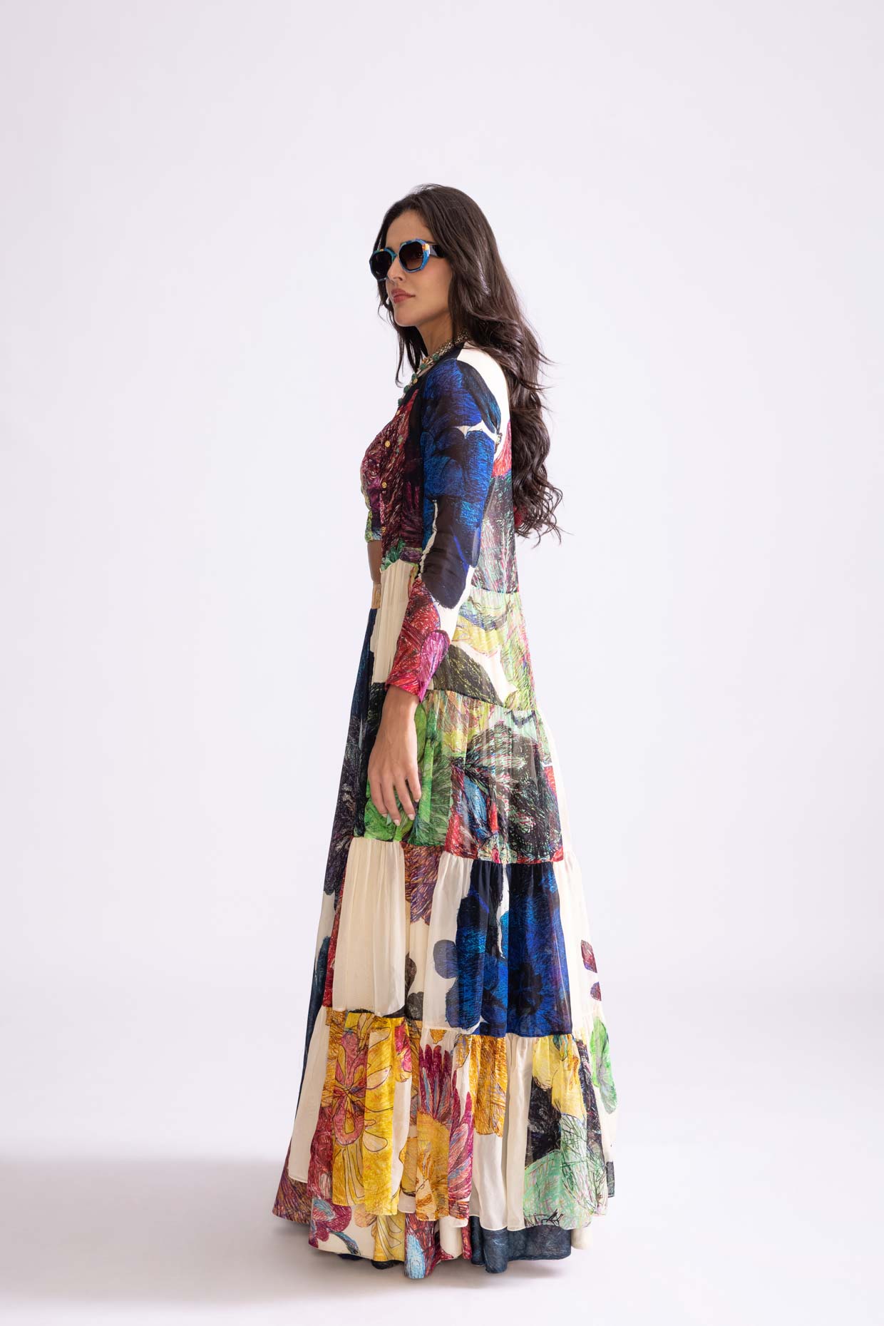 A model showcasing Magnolia Cape Daisy Print Tiered Cape by Saaksha And Kinni from Saaksha And Kinni's collection