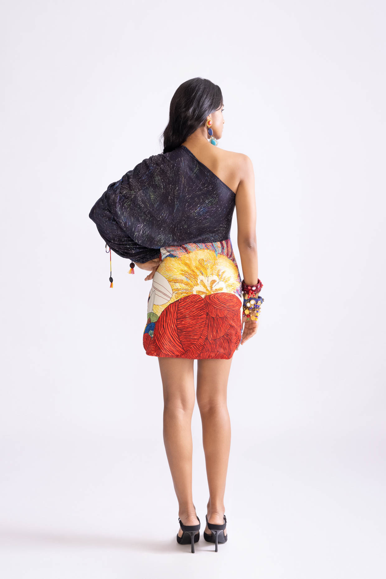 A model showcasing Dora Dress Tribal Print One Shoulder Mini Dress by Saaksha And Kinni from Saaksha And Kinni's collection