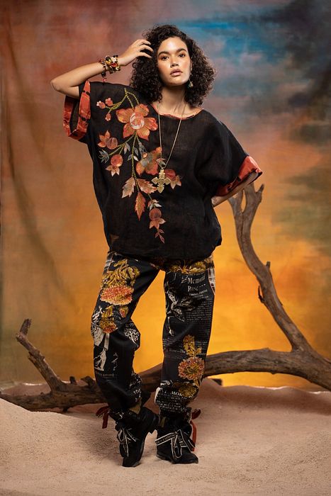 A model showcasing Black Cedar Pants by Capisvirleo from Capisvirleo's collection