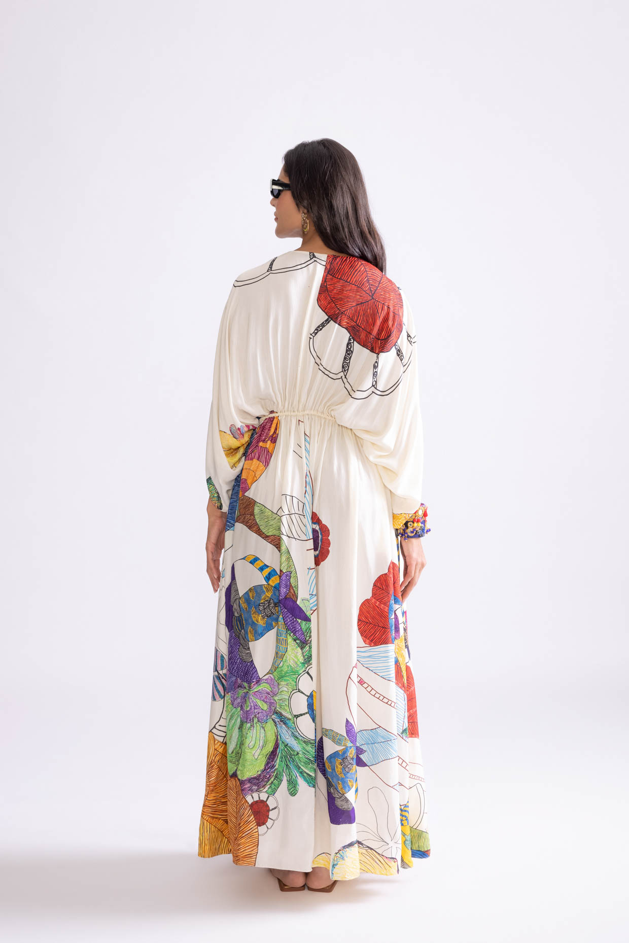 A model showcasing Shiloh Kaftan Tribal Print Kaftan Dress by Saaksha And Kinni from Saaksha And Kinni's collection