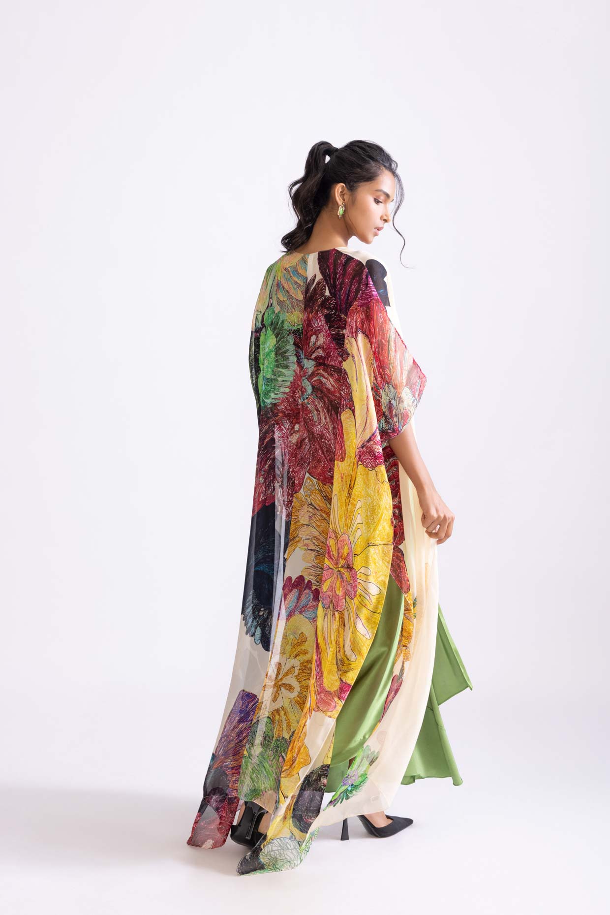 A model showcasing Sass Skirt Draped Green Skirt With Slit by Saaksha And Kinni from Saaksha And Kinni's collection