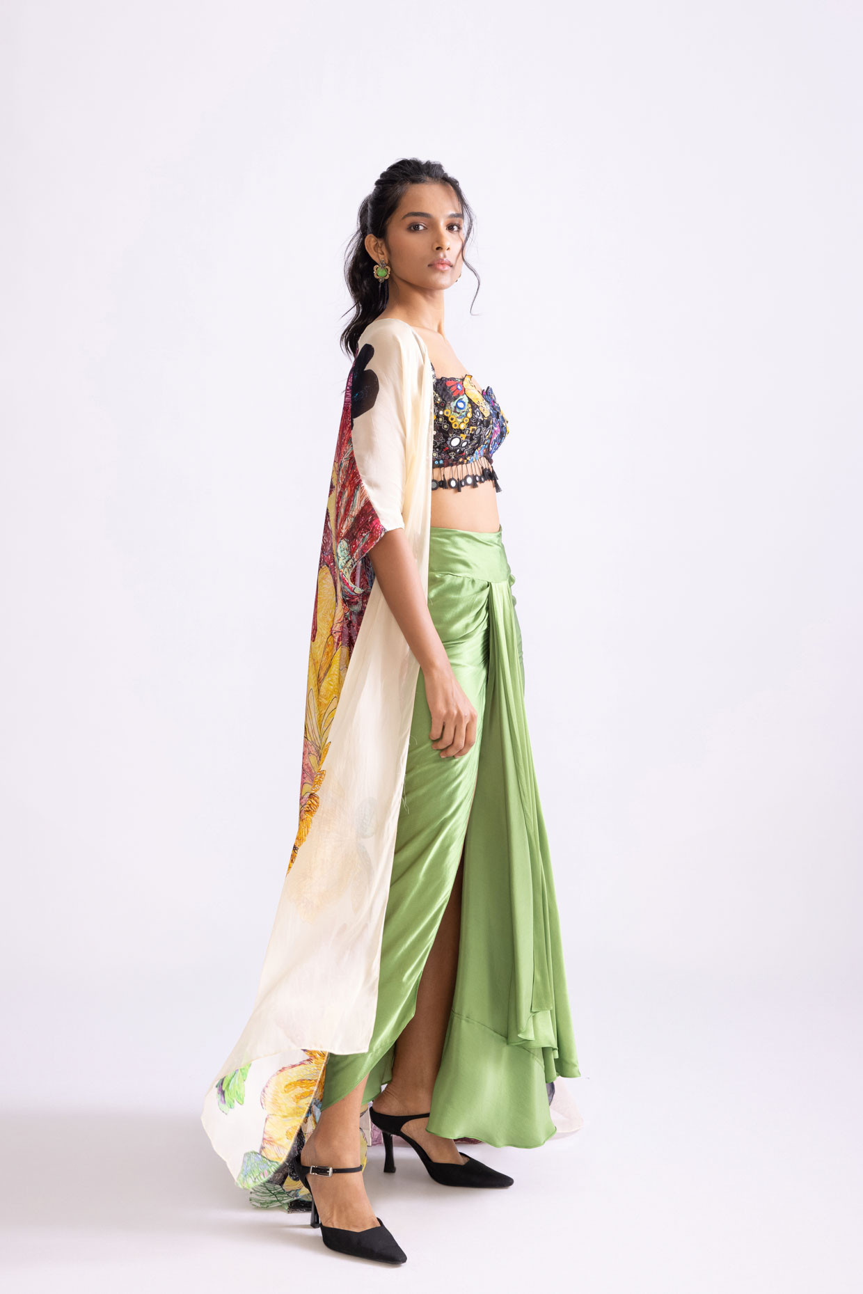 A model showcasing Sass Skirt Draped Green Skirt With Slit by Saaksha And Kinni from Saaksha And Kinni's collection