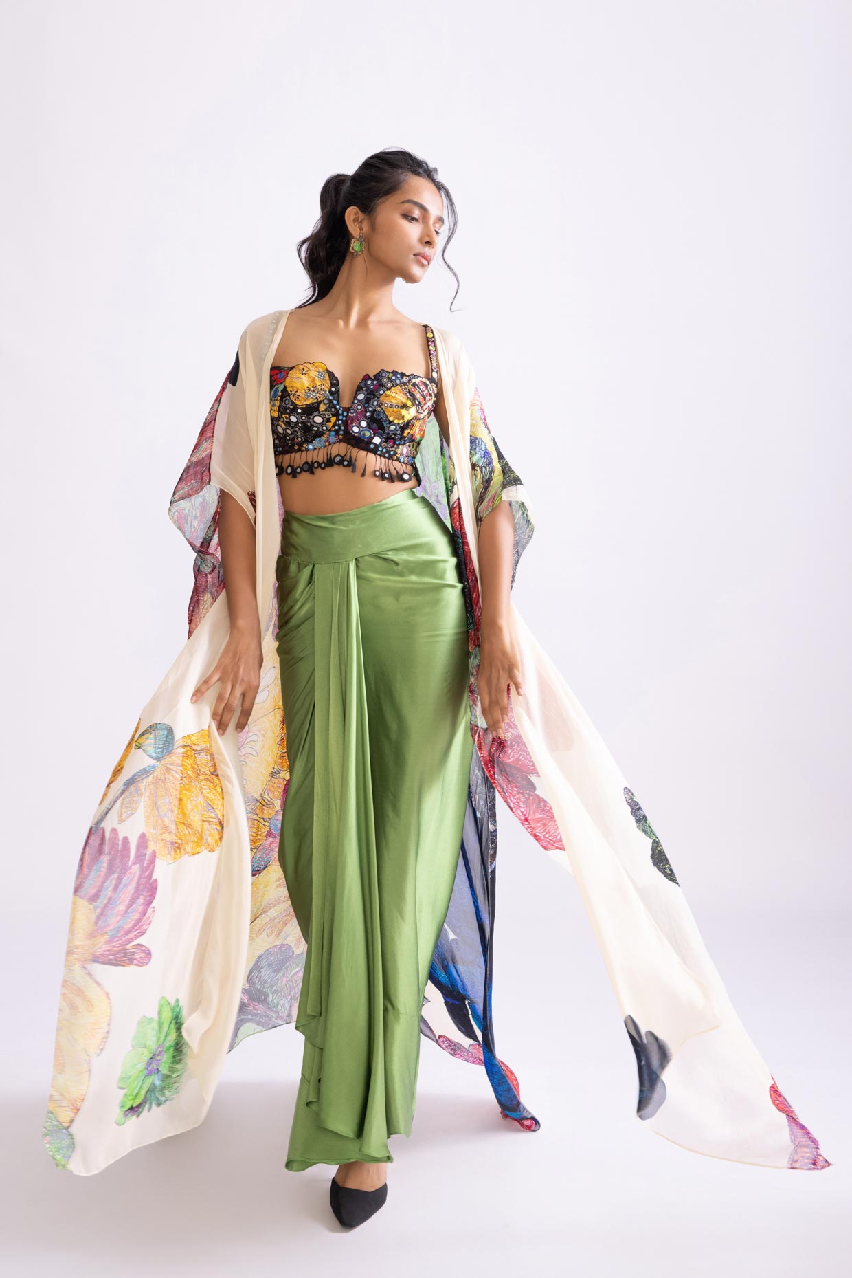 A model showcasing Sass Skirt Draped Green Skirt With Slit by Saaksha And Kinni from Saaksha And Kinni's collection