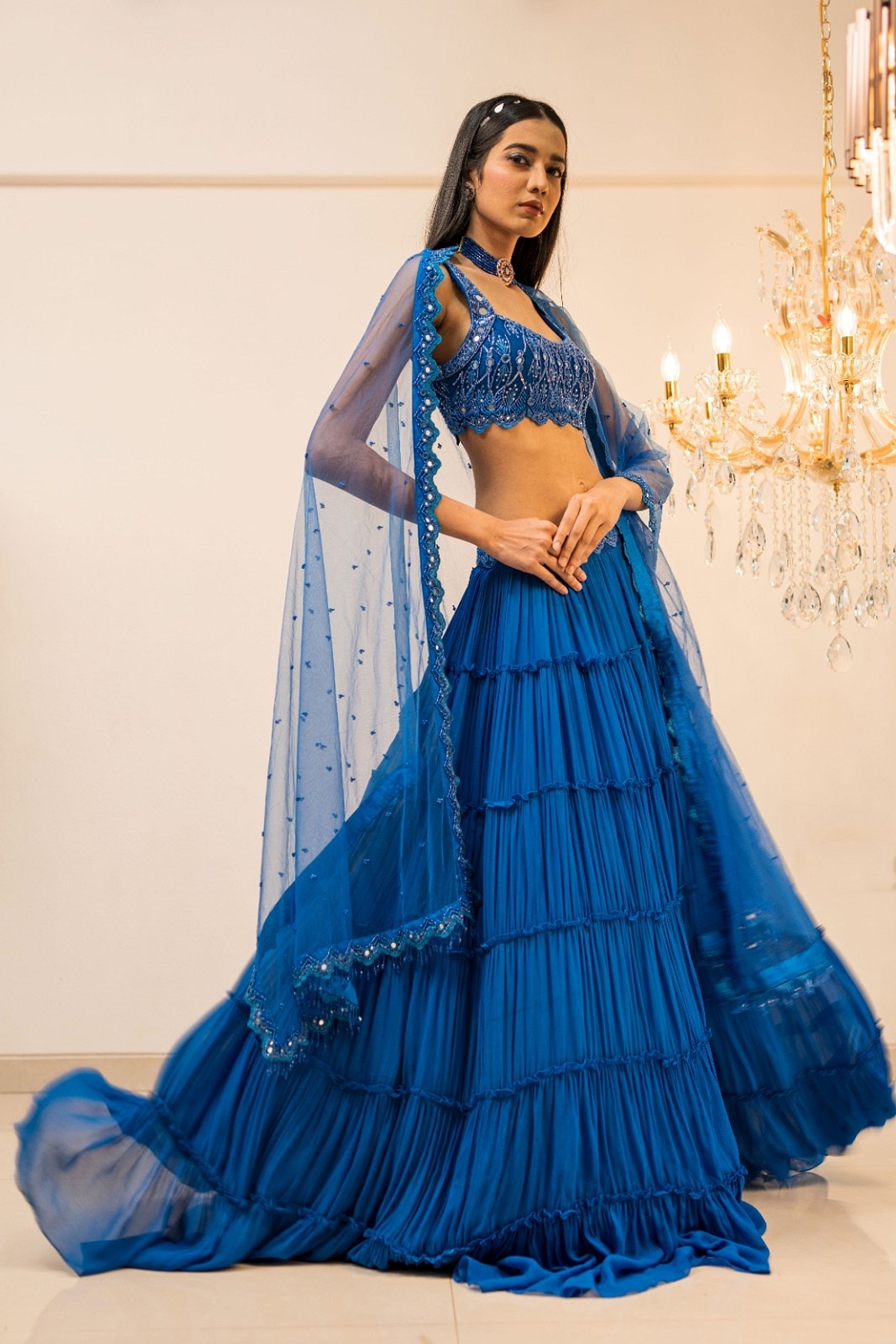 A model showcasing Blue Tiered Mirror Work Lehenga Set Feature image by Foram Patel from Foram Patel's collection