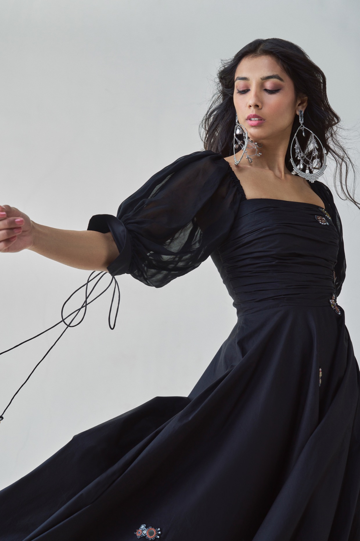 A model showcasing Kinni Dress Black Flared Dress by Saaksha And Kinni from Saaksha And Kinni's collection