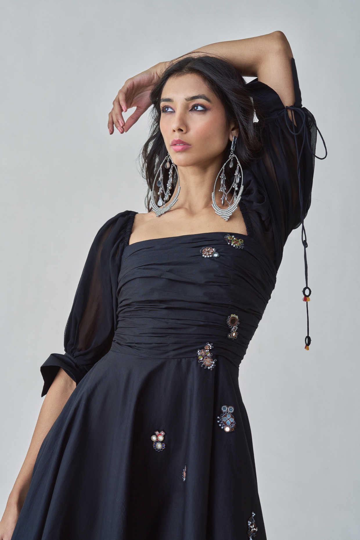 A model showcasing Kinni Dress Black Flared Dress by Saaksha And Kinni from Saaksha And Kinni's collection
