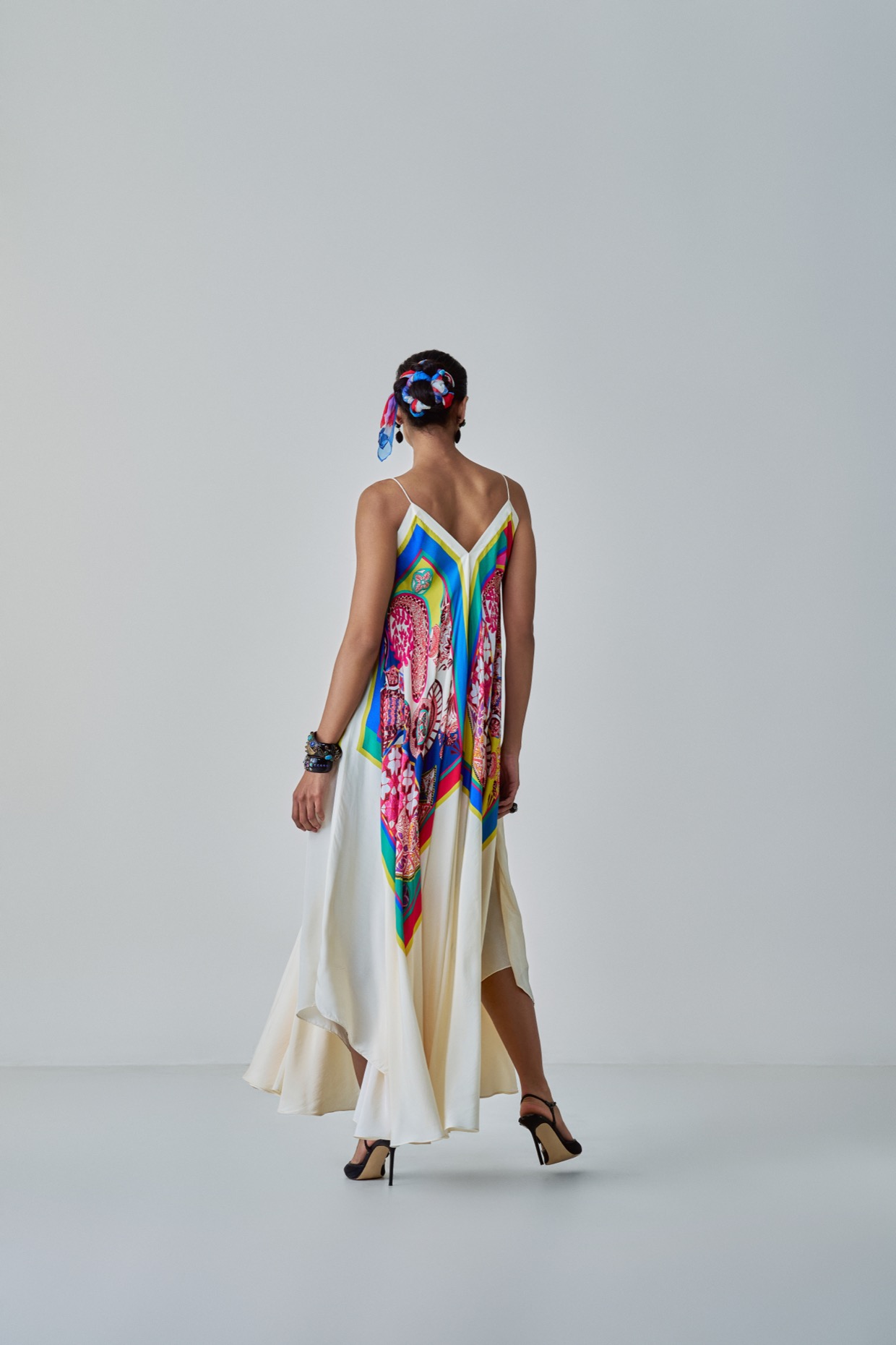 A model showcasing Yazmine Dress Paisley Print Asymmetric Dress by Saaksha And Kinni from Saaksha And Kinni's collection