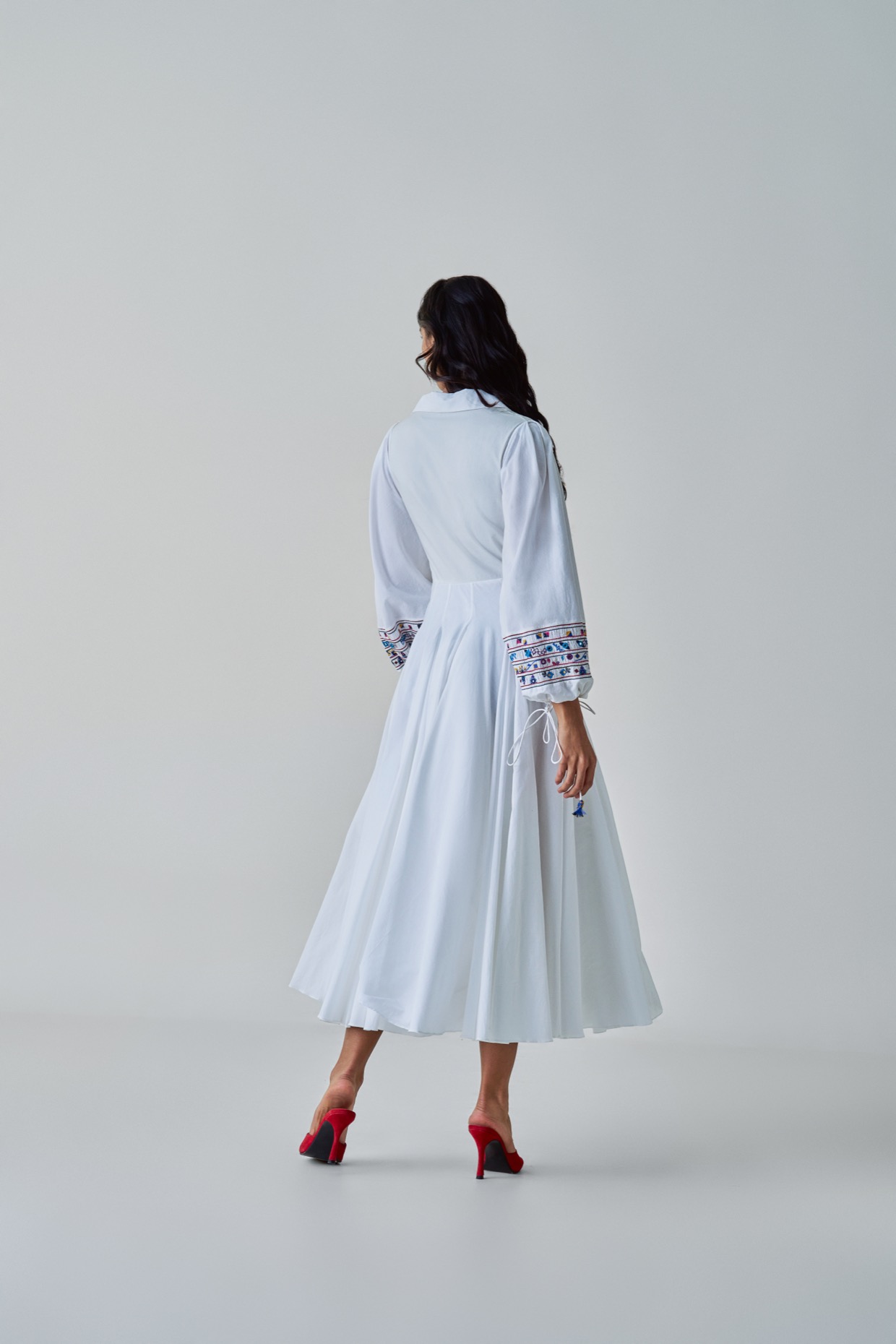 A model showcasing Annie Dress White Midi Dress by Saaksha And Kinni from Saaksha And Kinni's collection