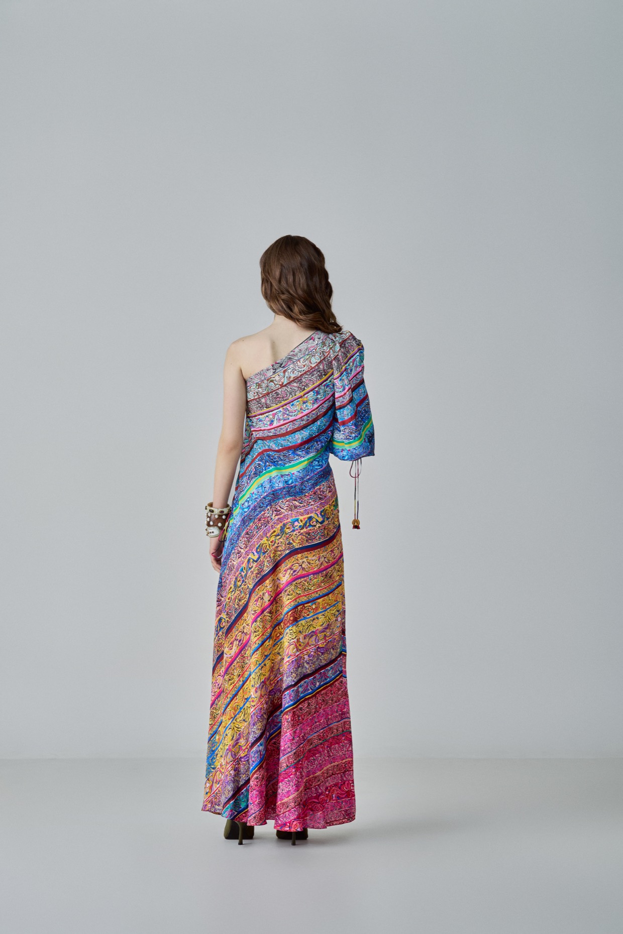 A model showcasing Alina Dress One Shoulder Maxi Dress by Saaksha And Kinni from Saaksha And Kinni's collection