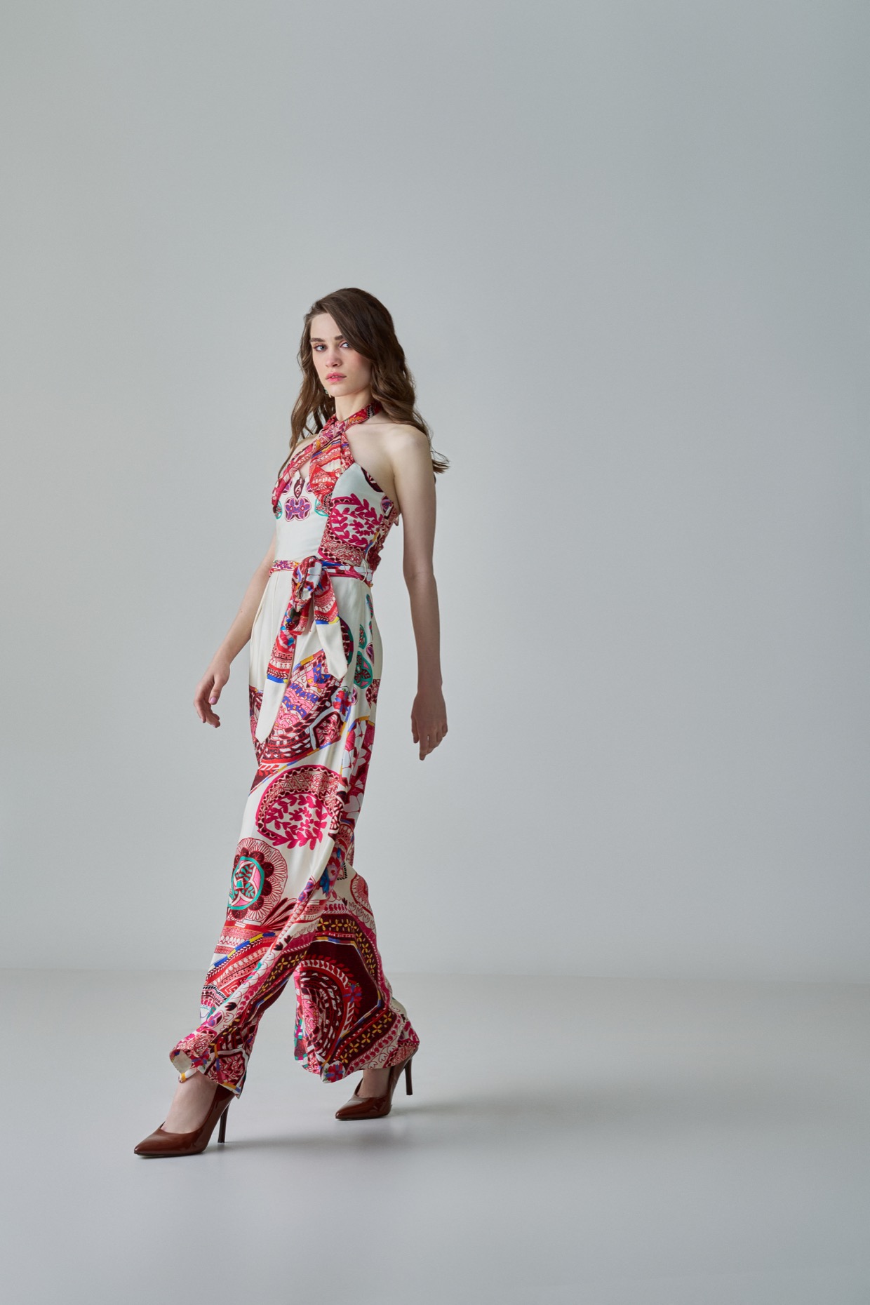 A model showcasing Alexa Jumpsuit Ivory Halter Neck Jumpsuit by Saaksha And Kinni from Saaksha And Kinni's collection