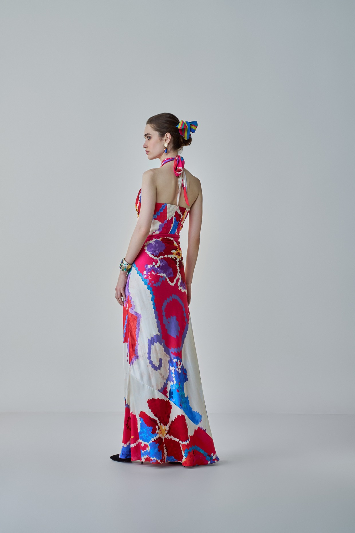 A model showcasing Shailee Dress Pink Red Halter Neck Dress by Saaksha And Kinni from Saaksha And Kinni's collection