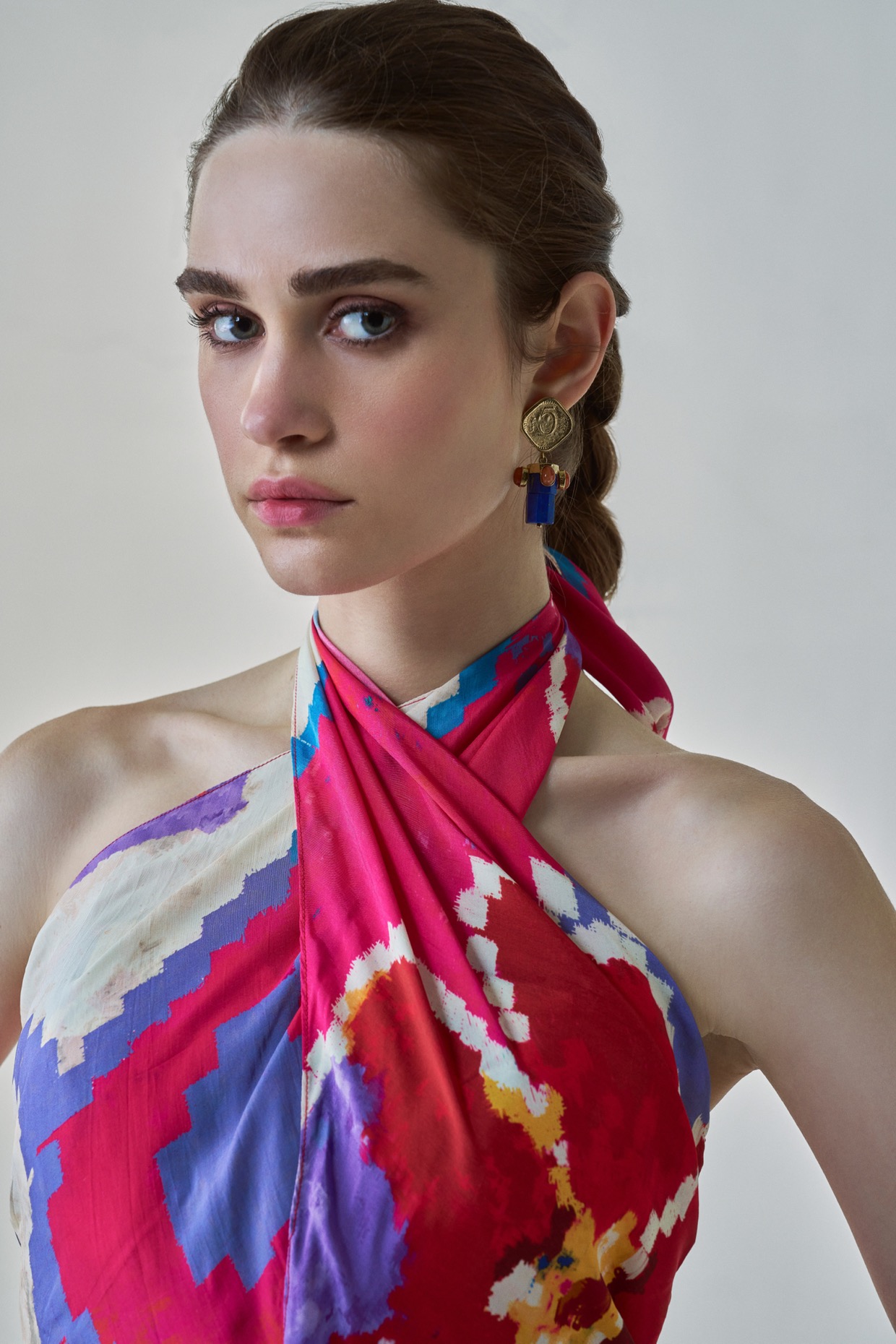 A model showcasing Shailee Dress Pink Red Halter Neck Dress by Saaksha And Kinni from Saaksha And Kinni's collection