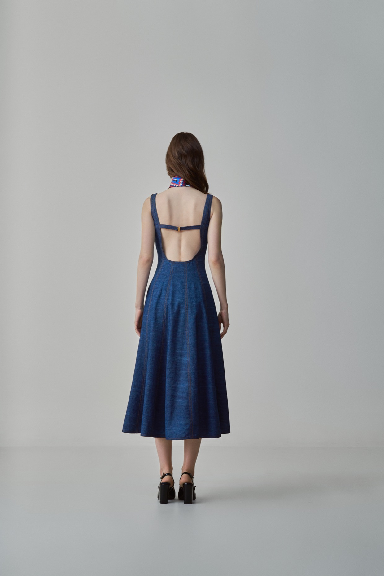 A model showcasing Emily Dress Blue Denim Midi Dress by Saaksha And Kinni from Saaksha And Kinni's collection