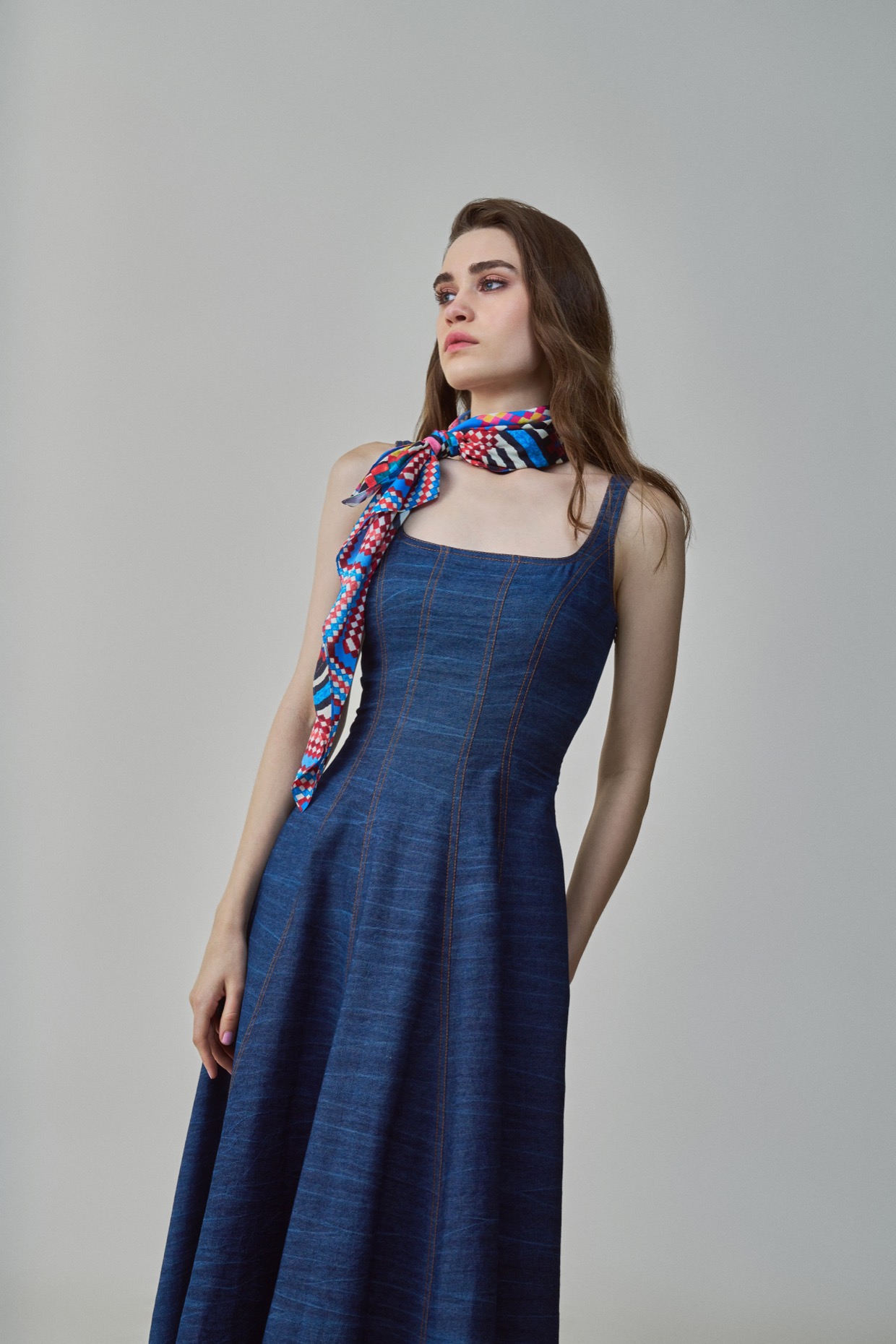 A model showcasing Emily Dress Blue Denim Midi Dress by Saaksha And Kinni from Saaksha And Kinni's collection
