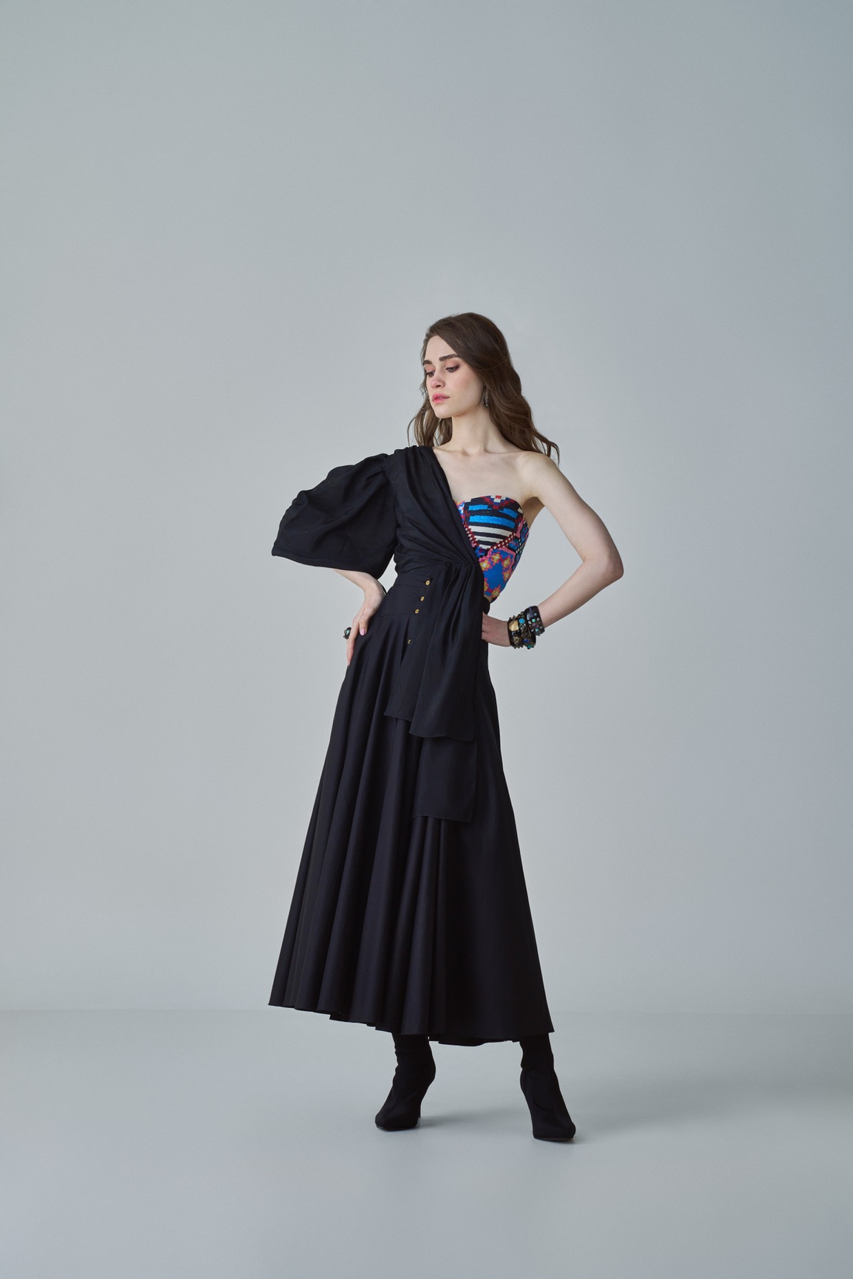 A model showcasing Ria Blouse Black Drape Blouse by Saaksha And Kinni from Saaksha And Kinni's collection
