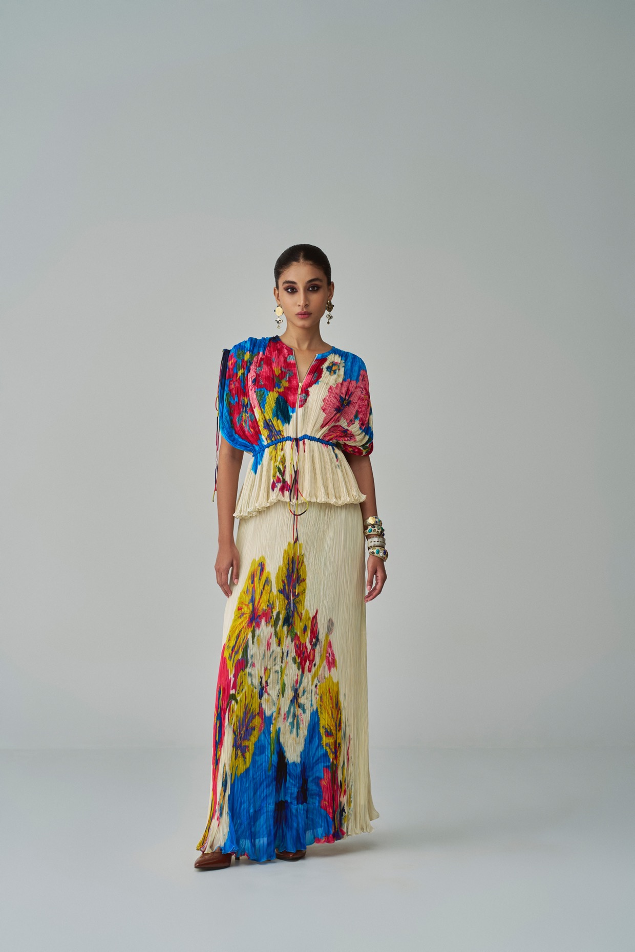A model showcasing Monica Skirt Ivory Maxi Skirt by Saaksha And Kinni from Saaksha And Kinni's collection