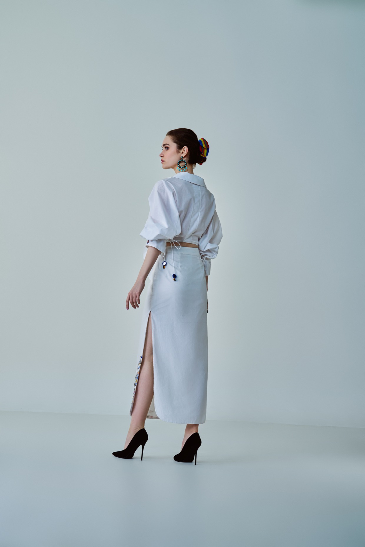 A model showcasing Olivia Shirt White Hand Embroidered Shirt by Saaksha And Kinni from Saaksha And Kinni's collection