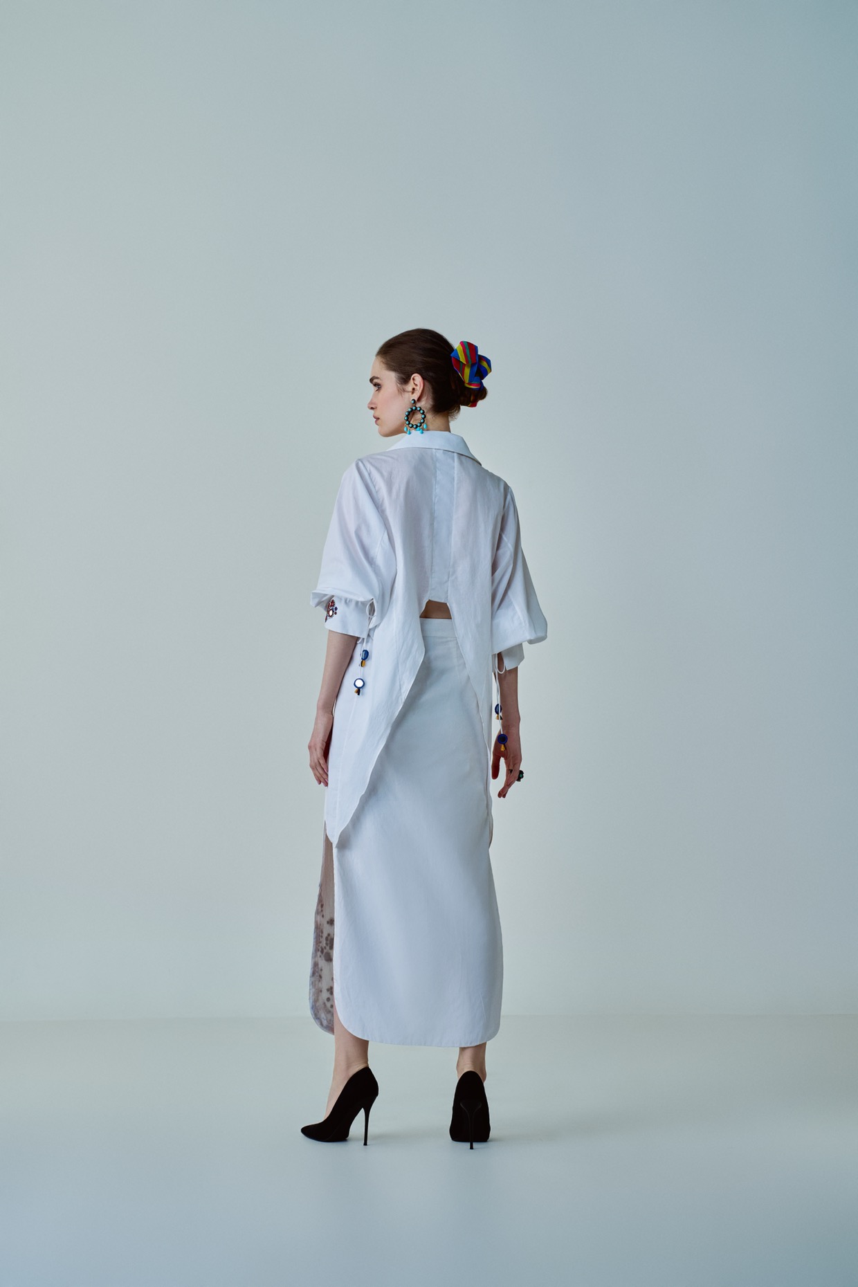 A model showcasing Olivia Shirt White Hand Embroidered Shirt by Saaksha And Kinni from Saaksha And Kinni's collection