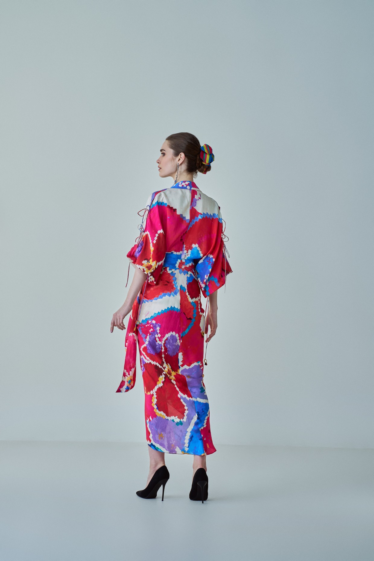 A model showcasing Evelyn Dress Pink Red Wrap Up Assymetric Dress by Saaksha And Kinni from Saaksha And Kinni's collection