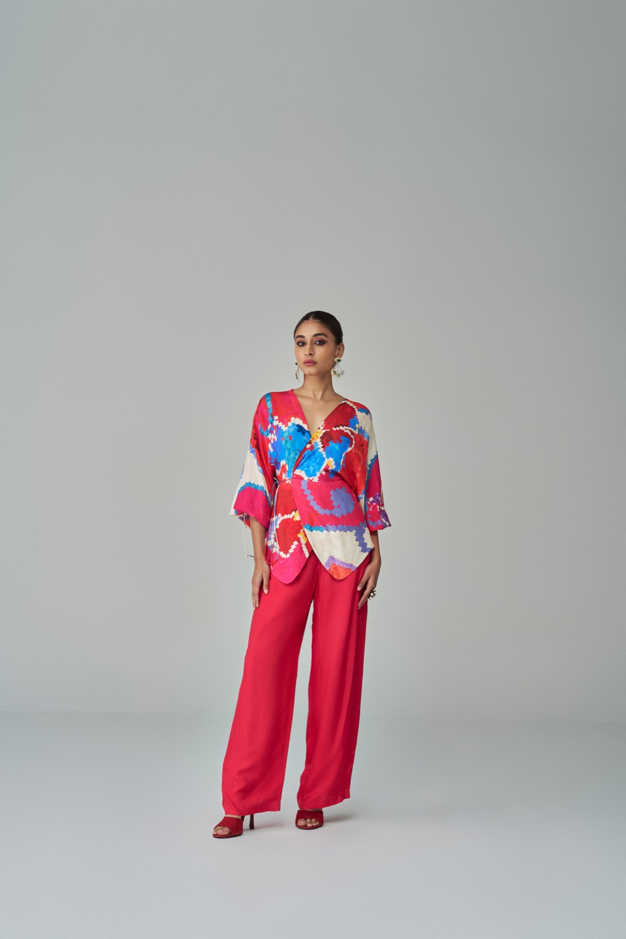 A model showcasing Nina Blouse Pink Red Wrap Up Blouse by Saaksha And Kinni from Saaksha And Kinni's collection