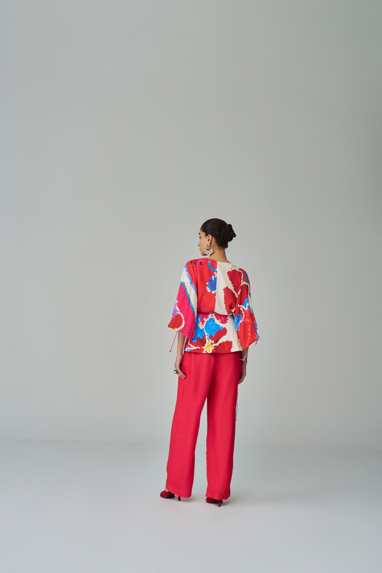 A model showcasing Mia Palazzo Pink Red High Waist Palazzo by Saaksha And Kinni from Saaksha And Kinni's collection