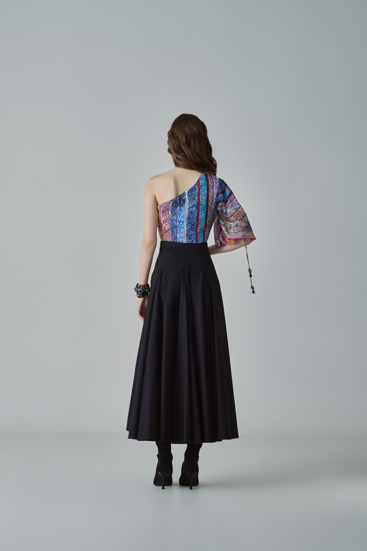 A model showcasing Rosie Blouse Block Printed One Shoulder Blouse by Saaksha And Kinni from Saaksha And Kinni's collection
