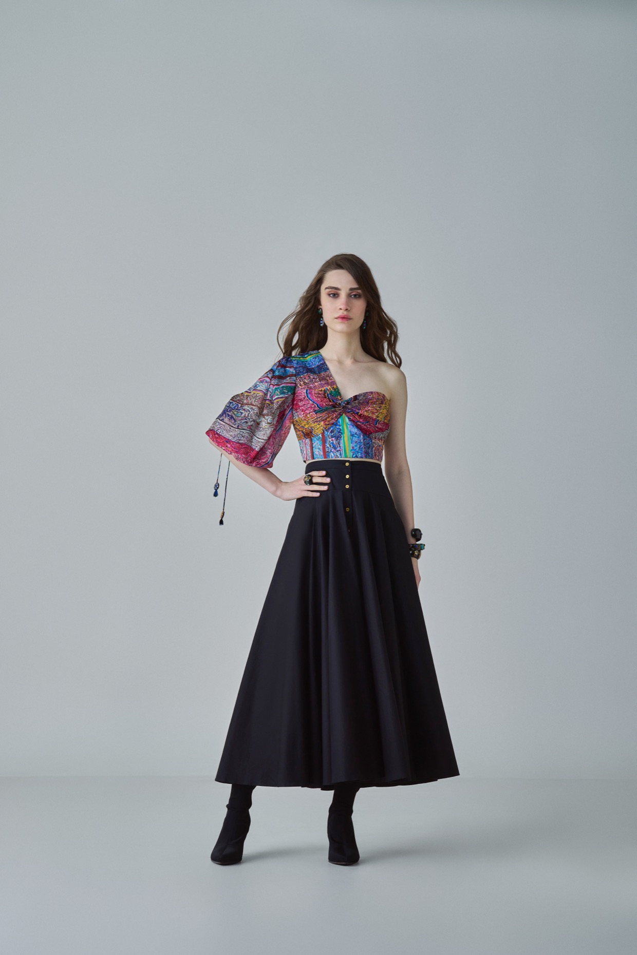 A model showcasing Rosie Blouse Block Printed One Shoulder Blouse by Saaksha And Kinni from Saaksha And Kinni's collection