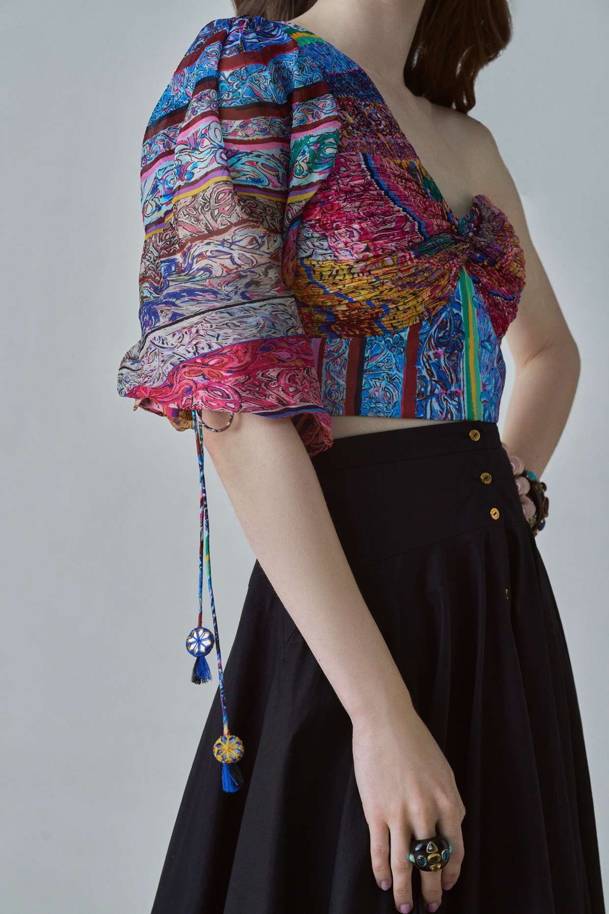 A model showcasing Rosie Blouse Block Printed One Shoulder Blouse by Saaksha And Kinni from Saaksha And Kinni's collection