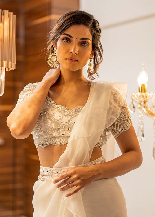 A model showcasing White Organza PreDraped Ruffle Saree Set With Belt by Foram Patel from Foram Patel's collection