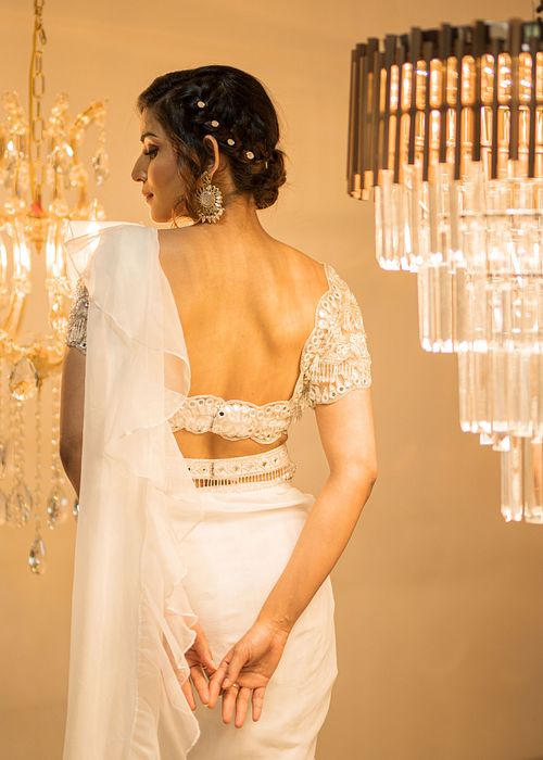 A model showcasing White Organza PreDraped Ruffle Saree Set With Belt by Foram Patel from Foram Patel's collection