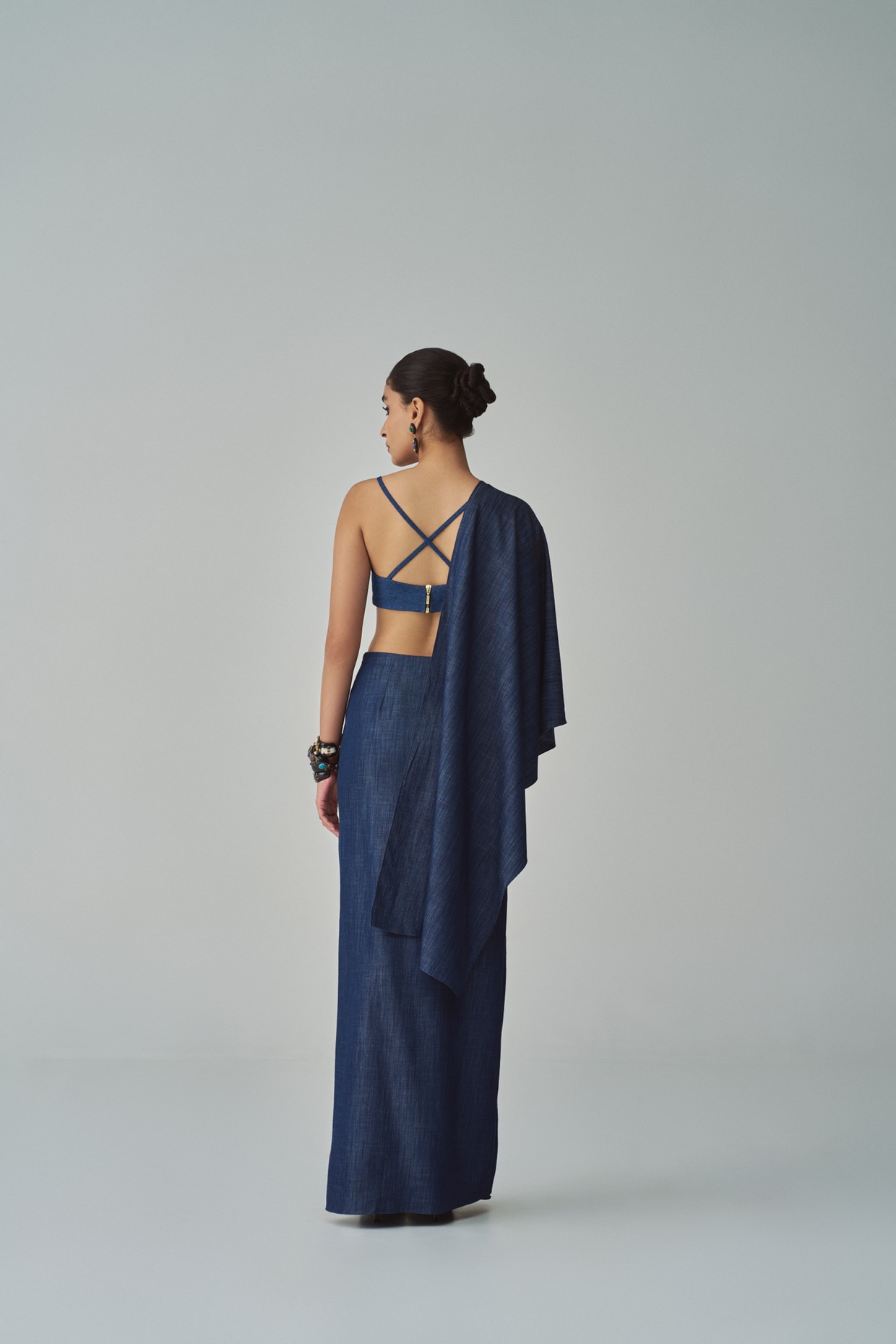 A model showcasing Lara Bralette Blue Denim Bralette by Saaksha And Kinni from Saaksha And Kinni's collection