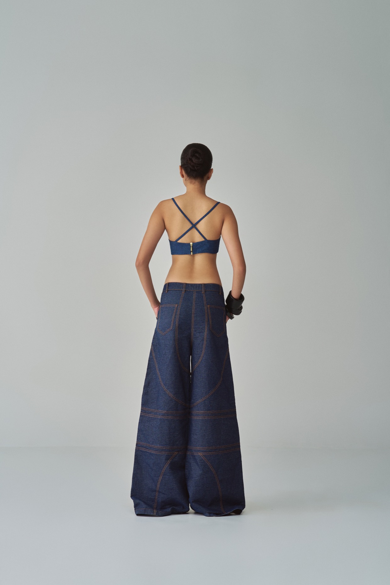 A model showcasing Lara Jeans Mid Rise Flared Jeans by Saaksha And Kinni from Saaksha And Kinni's collection