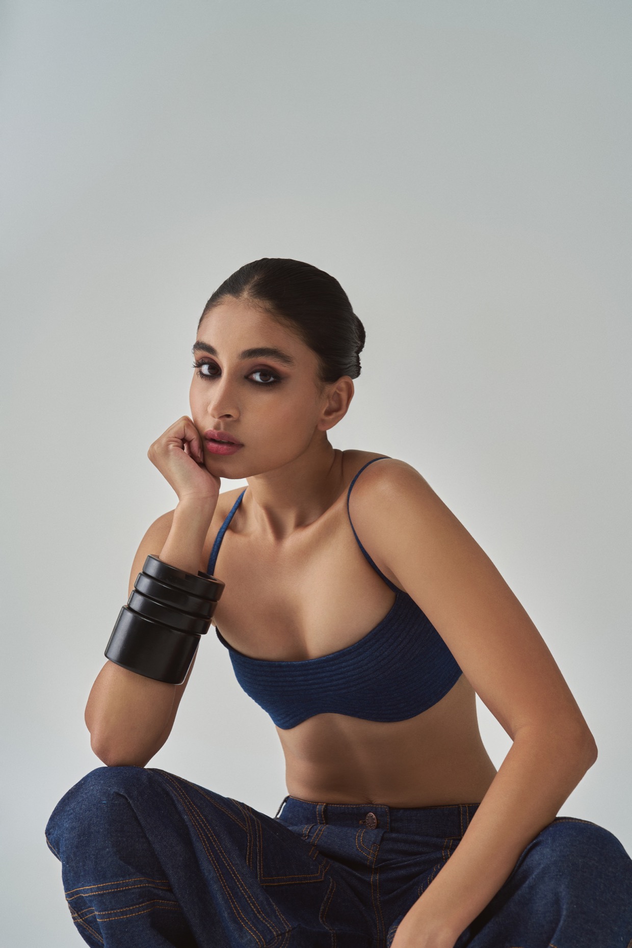 A model showcasing Lara Jeans Mid Rise Flared Jeans by Saaksha And Kinni from Saaksha And Kinni's collection