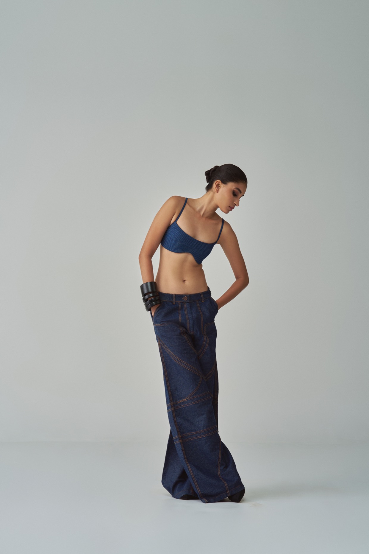 A model showcasing Lara Jeans Mid Rise Flared Jeans by Saaksha And Kinni from Saaksha And Kinni's collection