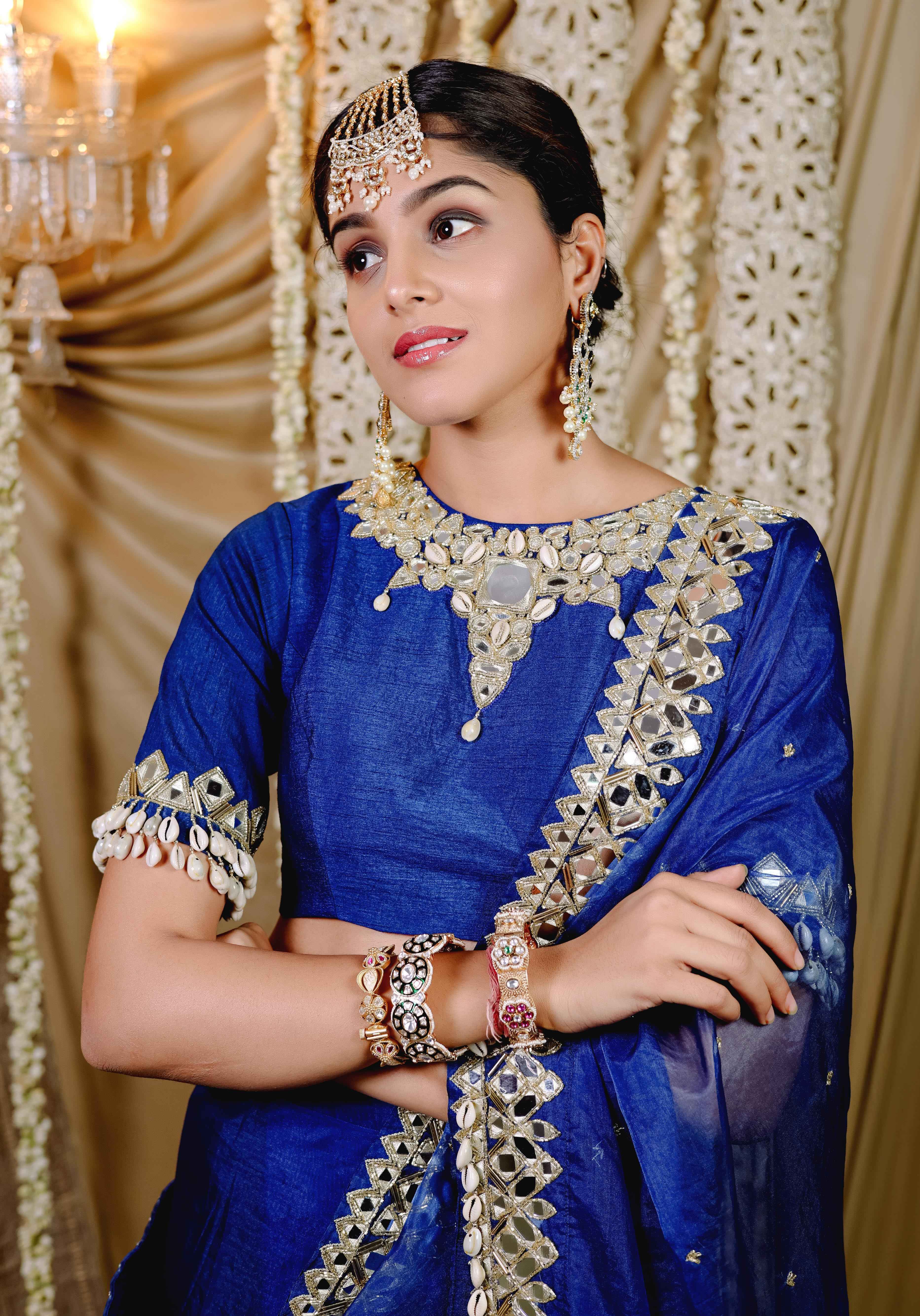 A model showcasing Dark Blue Embroidered Predraped Saree Set by Foram Patel from Foram Patel's collection