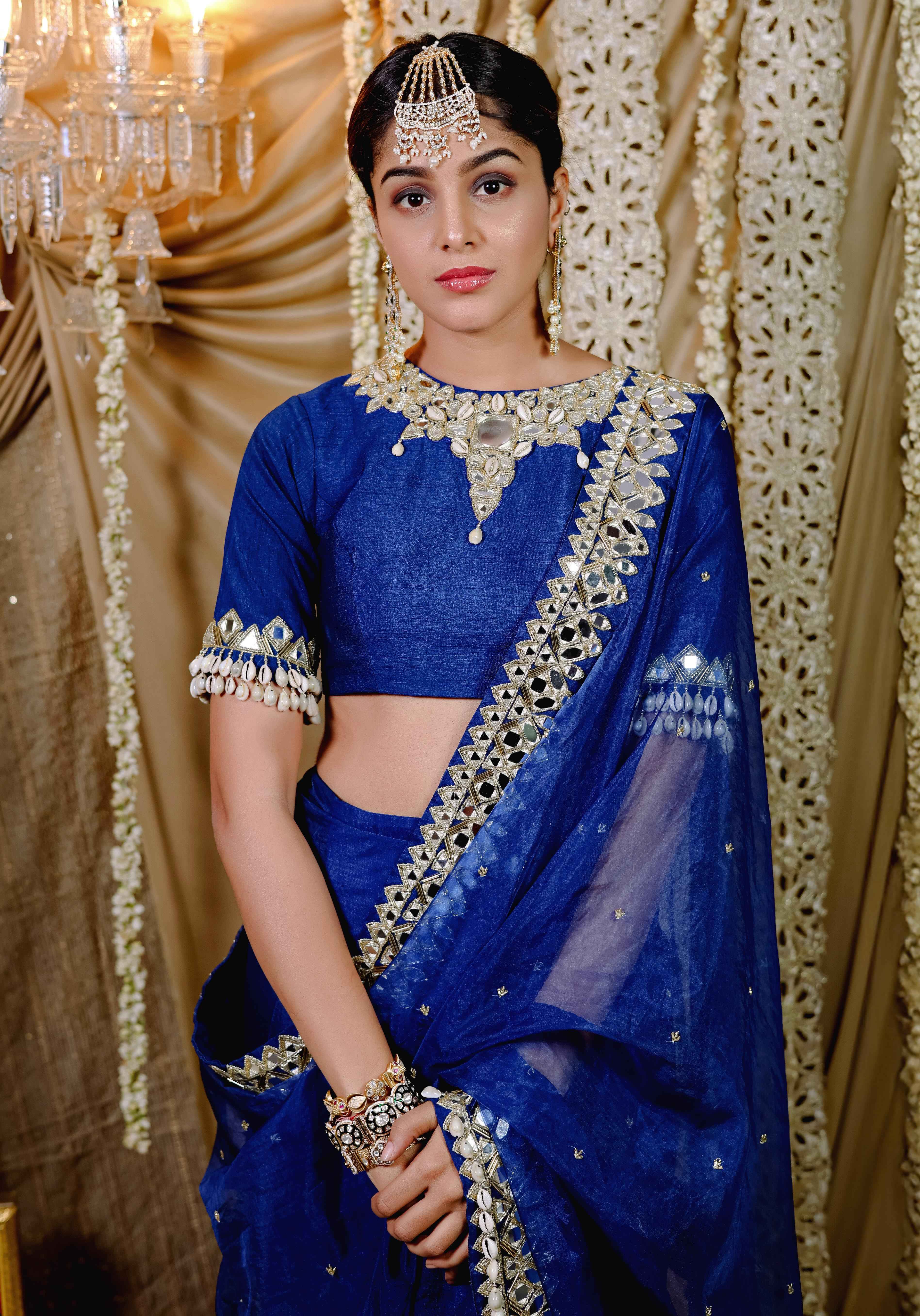 A model showcasing Dark Blue Embroidered Predraped Saree Set by Foram Patel from Foram Patel's collection