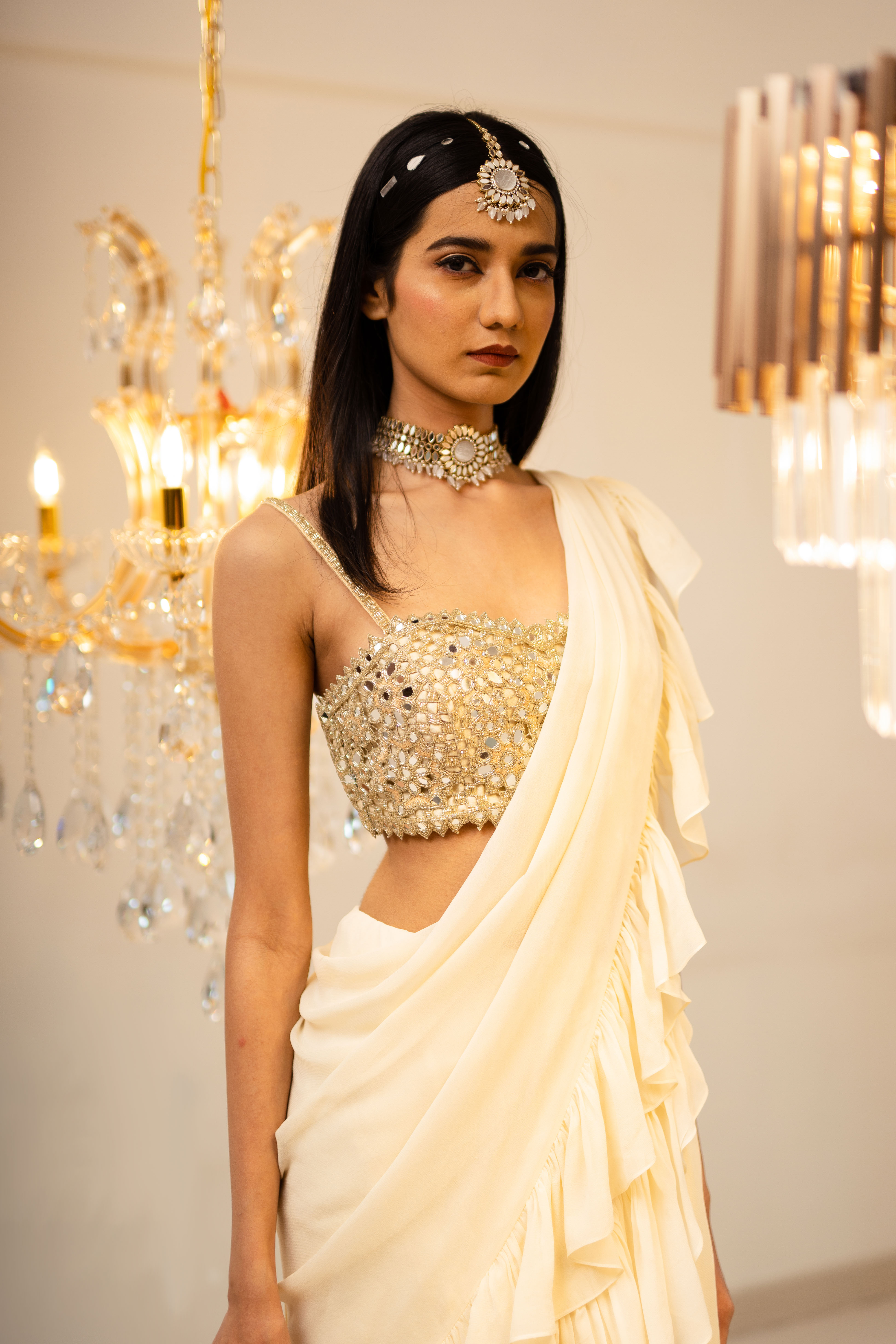 A model showcasing Cream PreDraped Ruffle Saree Set by Foram Patel from Foram Patel's collection