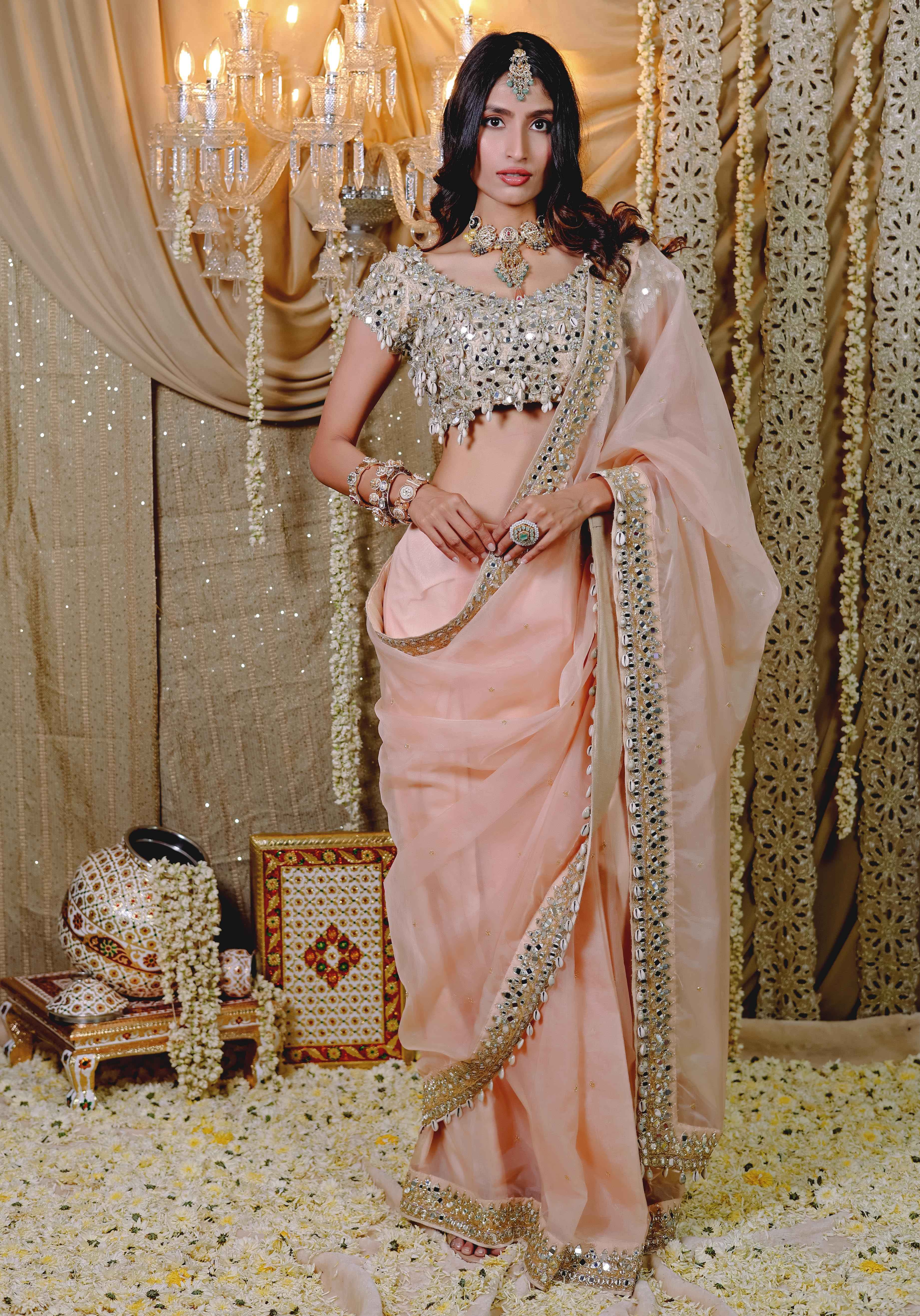 A model showcasing Peach Embroidered Predraped Saree Set by Foram Patel from Foram Patel's collection
