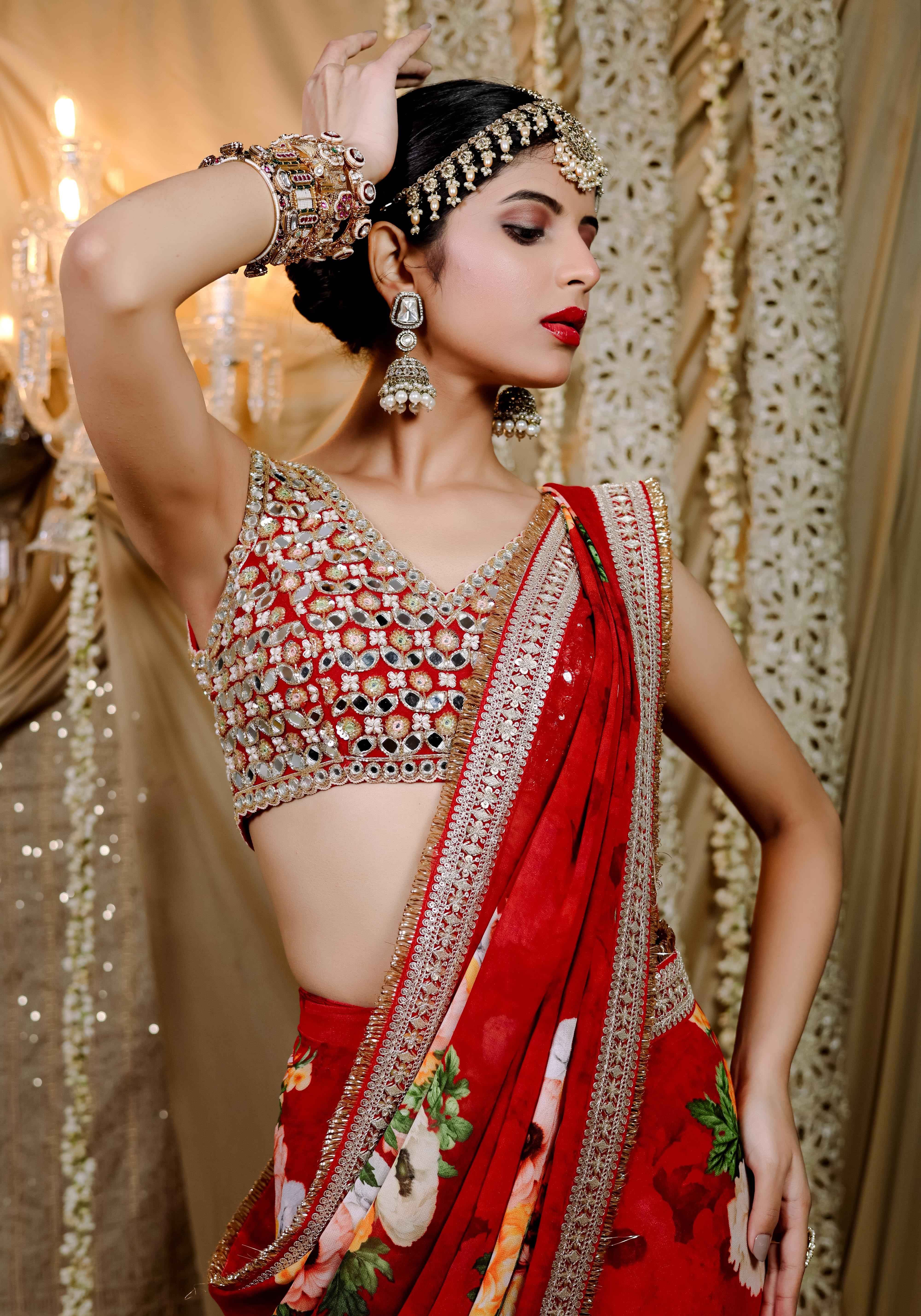 A model showcasing Red Floral Printed Predraped Saree Set by Foram Patel from Foram Patel's collection