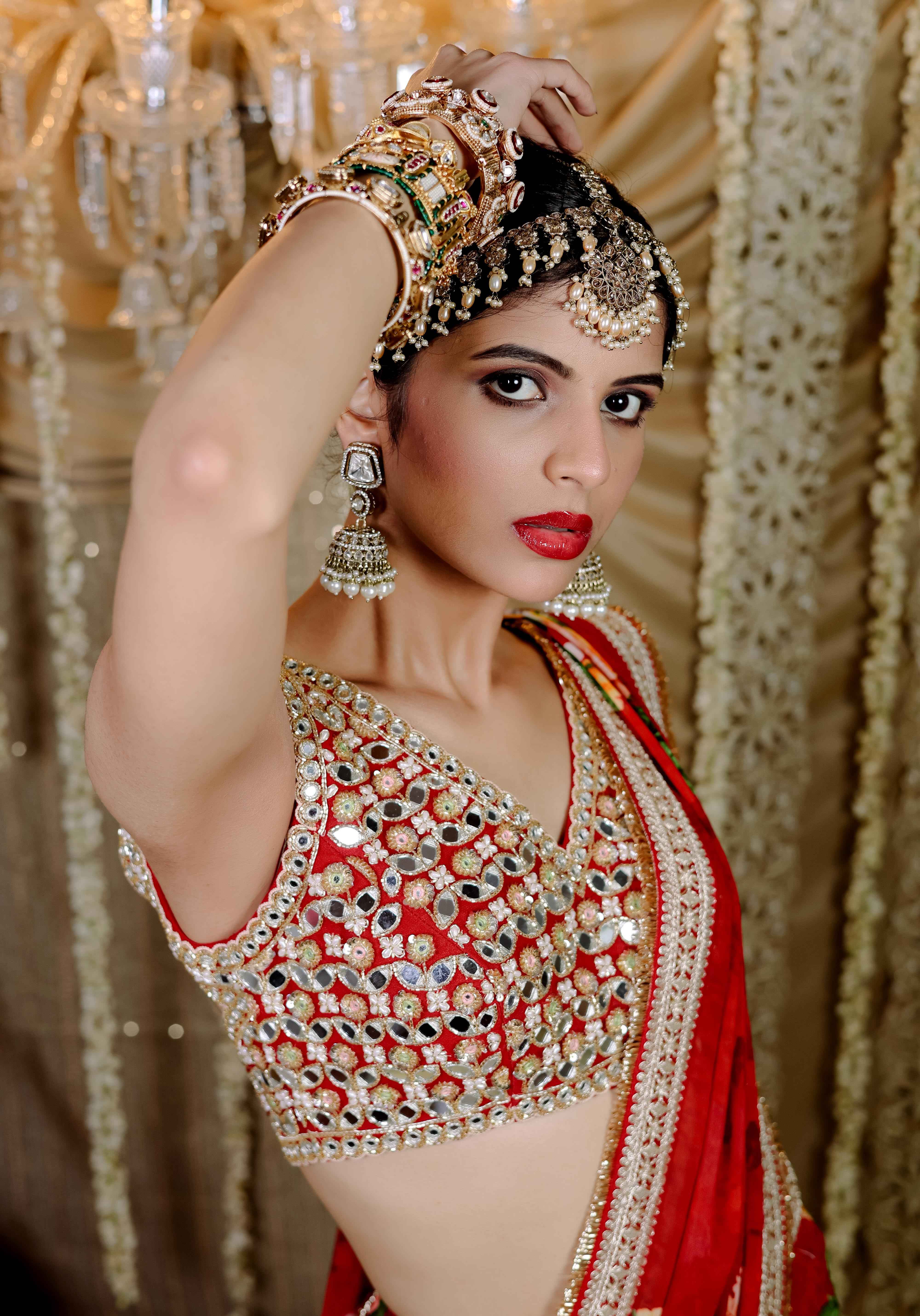 A model showcasing Red Floral Printed Predraped Saree Set by Foram Patel from Foram Patel's collection