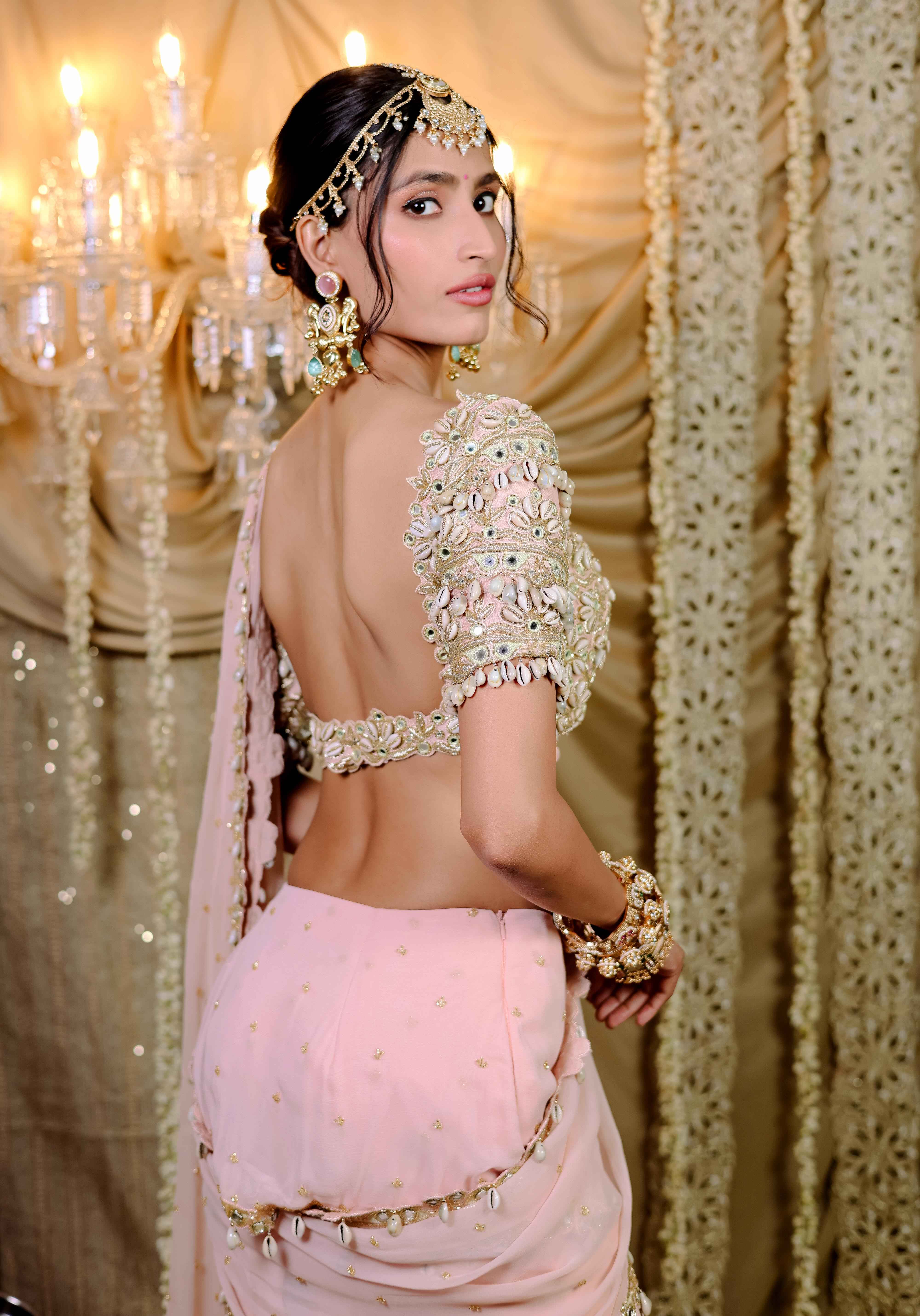 A model showcasing Peach Embroidered Mumtaz Saree Set by Foram Patel from Foram Patel's collection