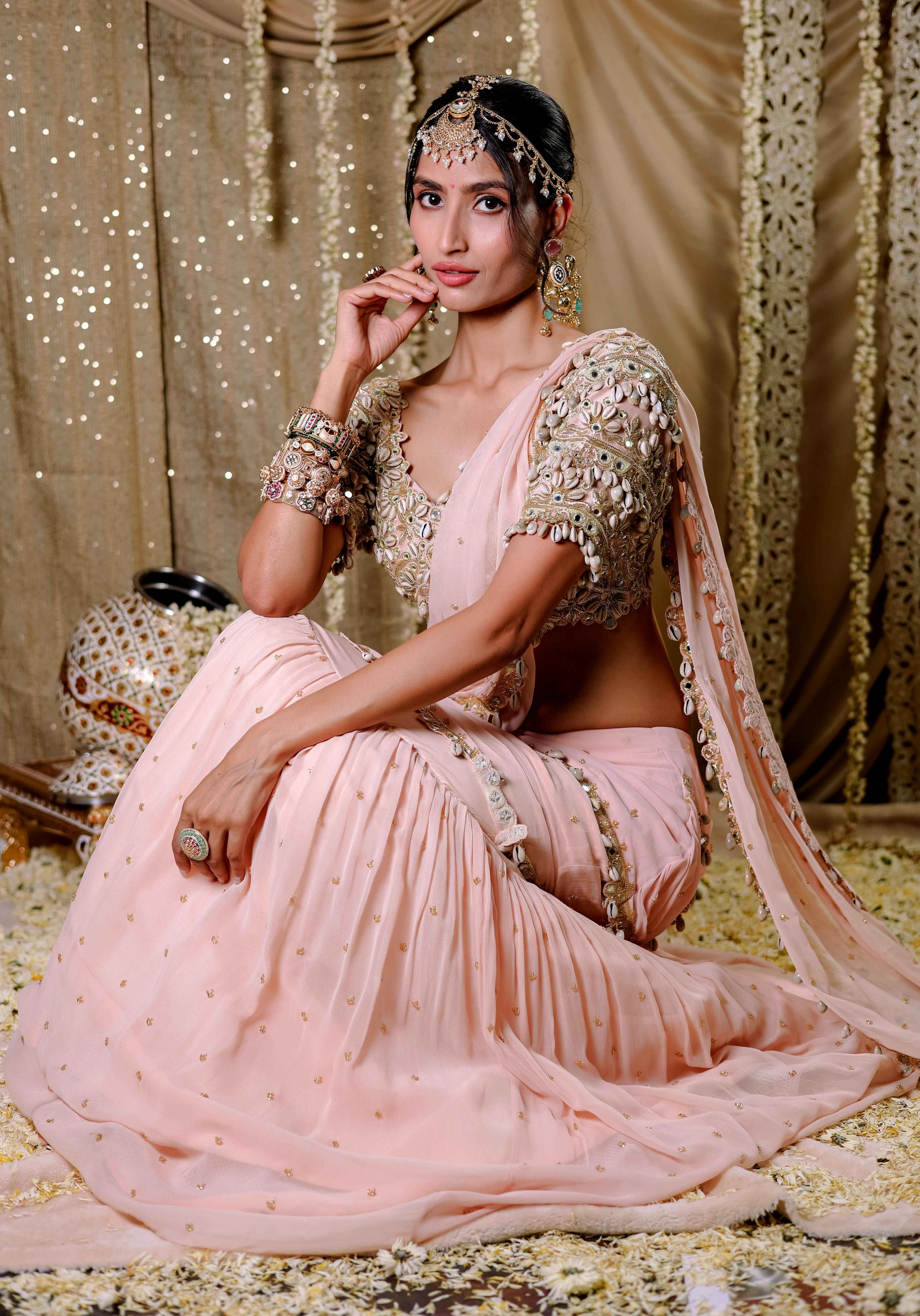 A model showcasing Peach Embroidered Mumtaz Saree Set by Foram Patel from Foram Patel's collection