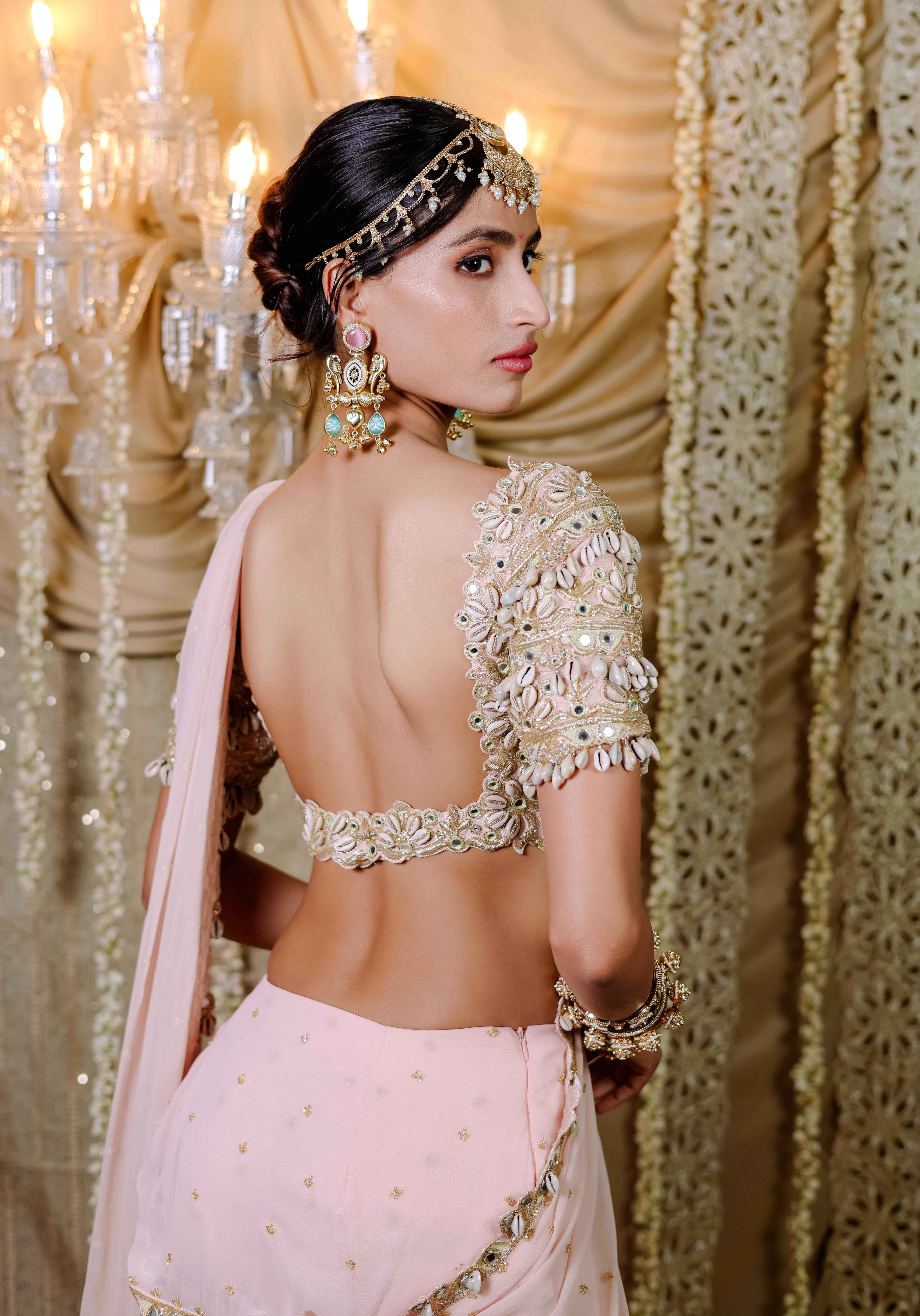 A model showcasing Peach Embroidered Mumtaz Saree Set by Foram Patel from Foram Patel's collection