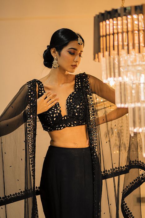 A model showcasing Black Ruffle Lehenga Set by Foram Patel from Foram Patel's collection